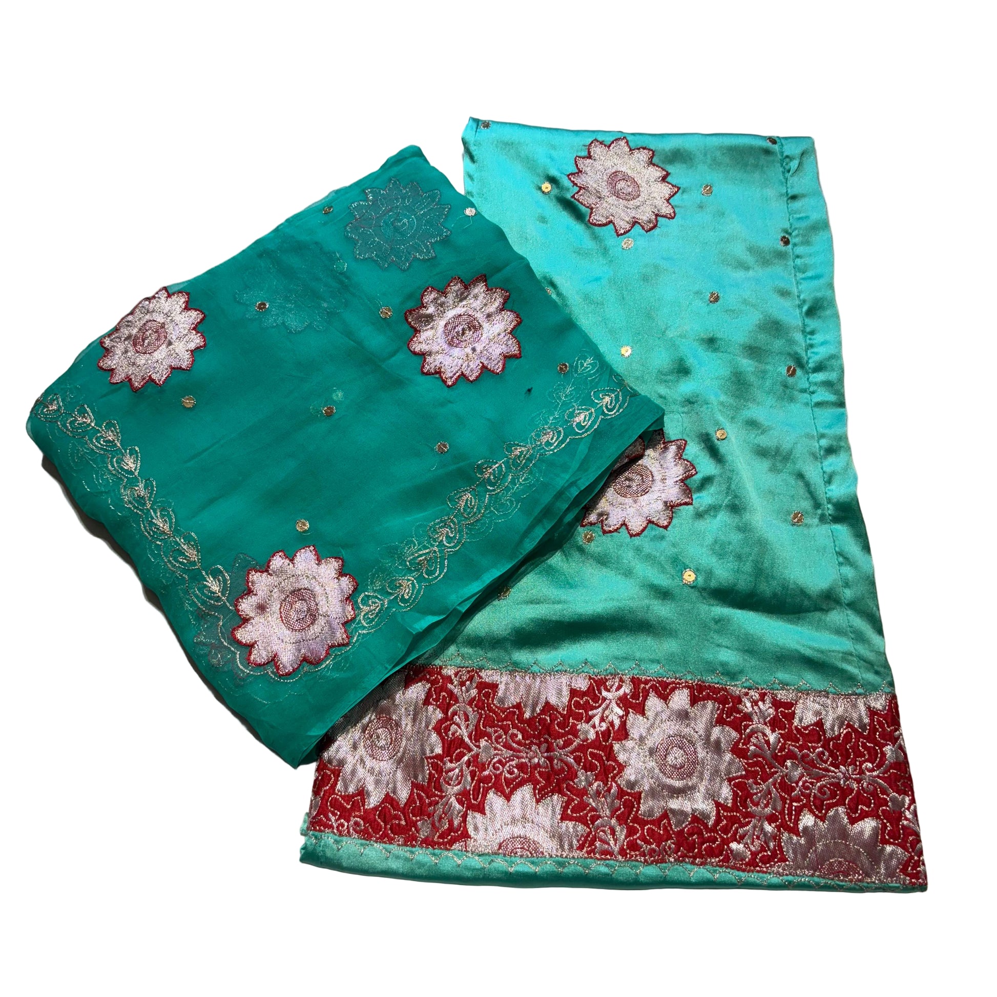 Turquoise fabric with floral embroidery on a light gray background