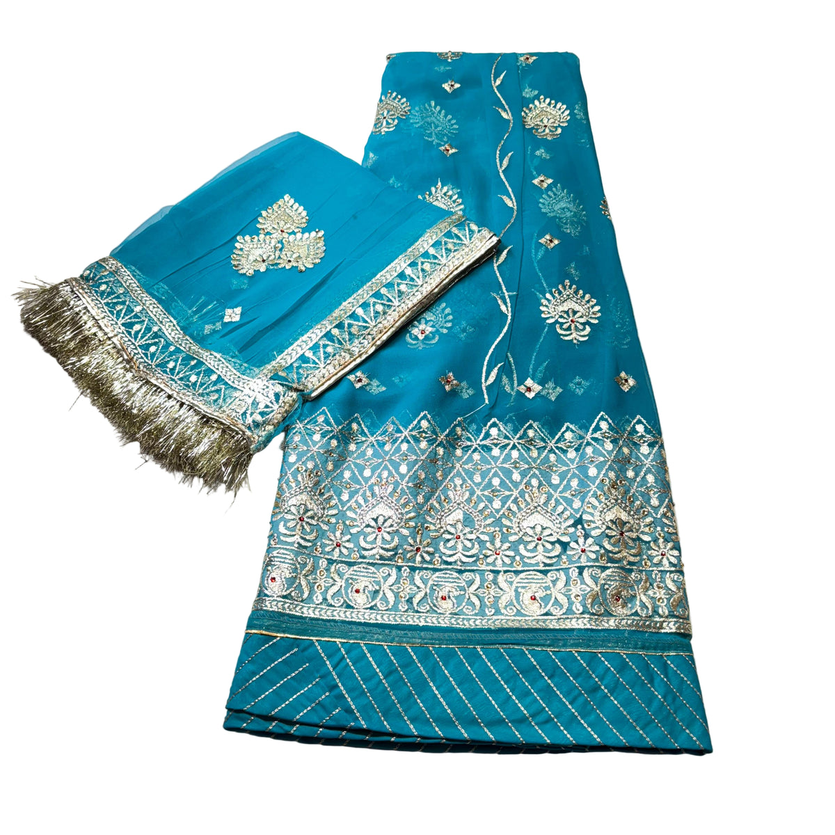 Teal fabric with intricate silver embroidery on a light gray surface