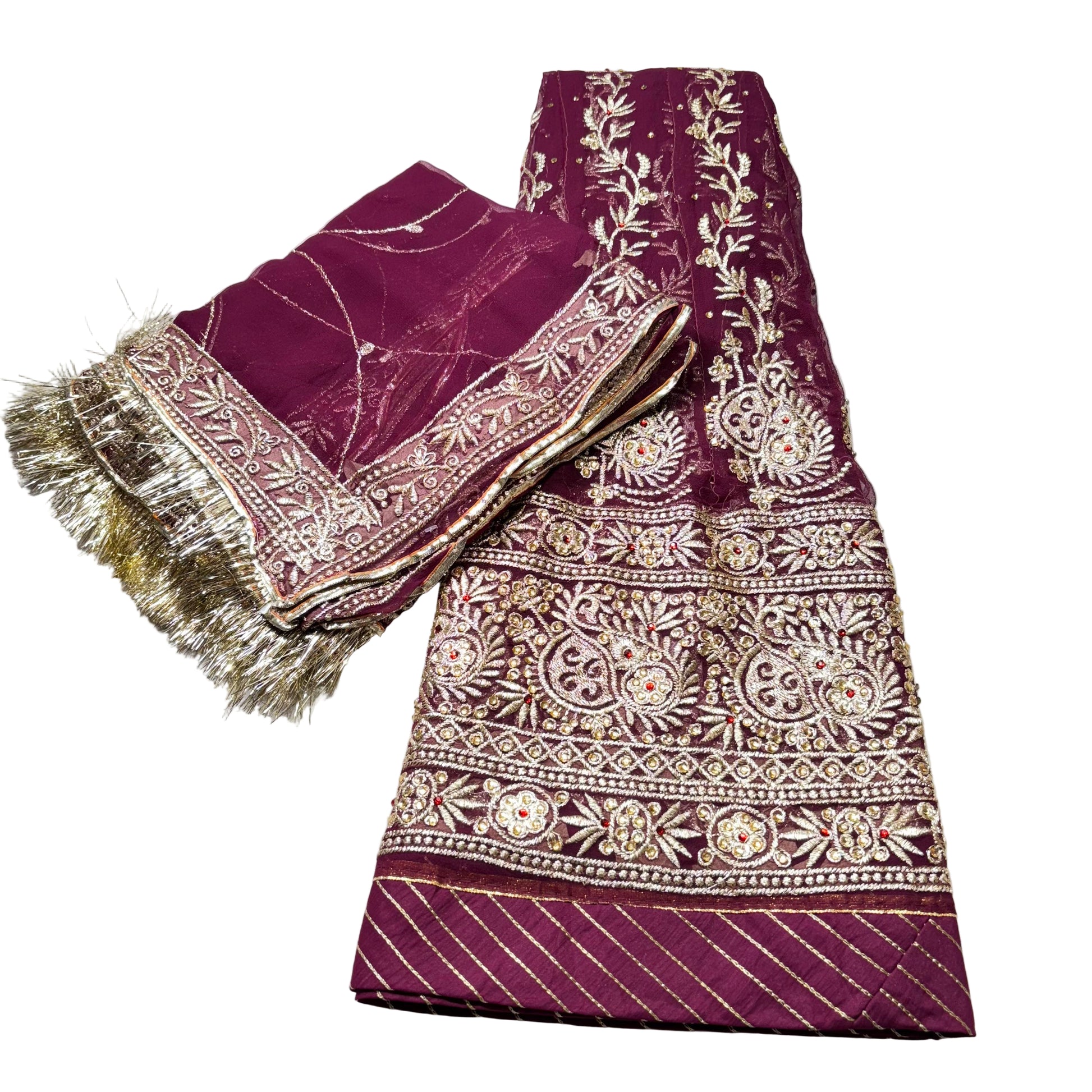 Purple fabric with gold embroidery on a white surface