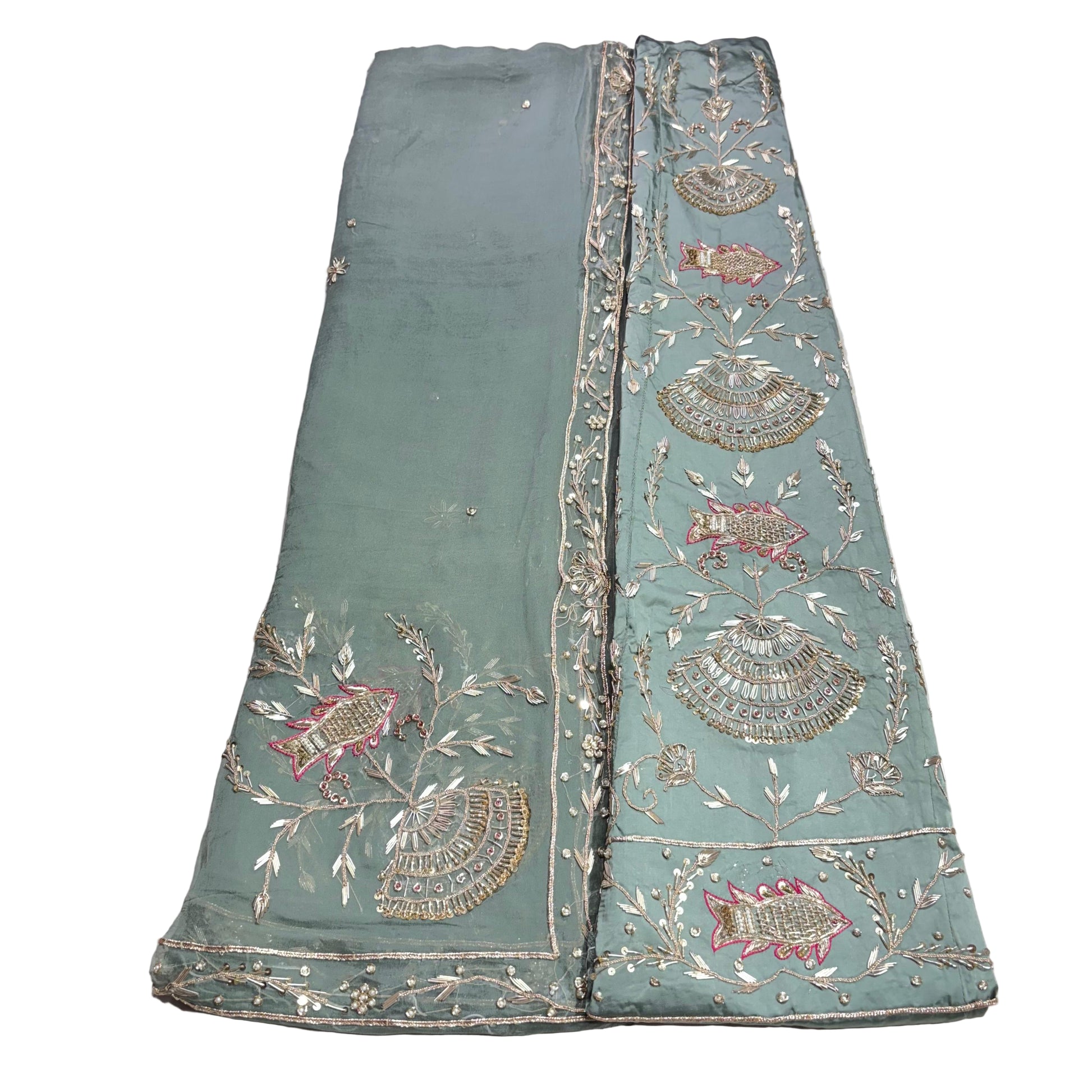 Light blue embroidered fabric with intricate patterns on a white background