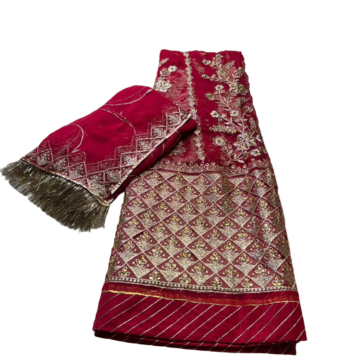 Red embroidered fabric with gold patterns on a light gray surface