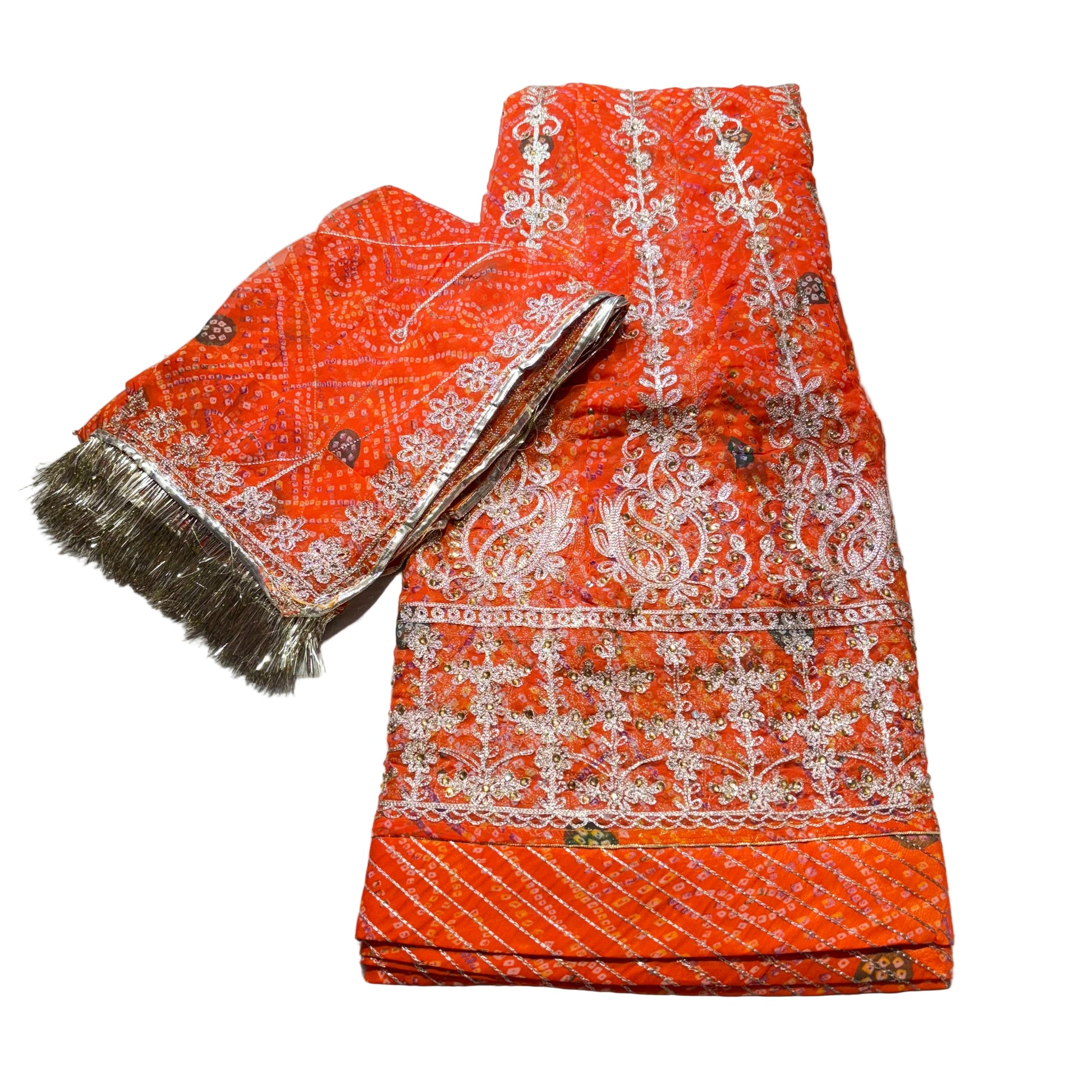 Orange fabric with white patterns and a gold broom on a white background