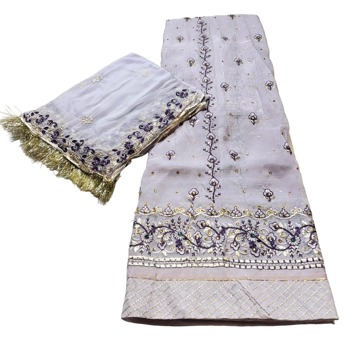 Embroidered fabric with gold and purple details on a light background