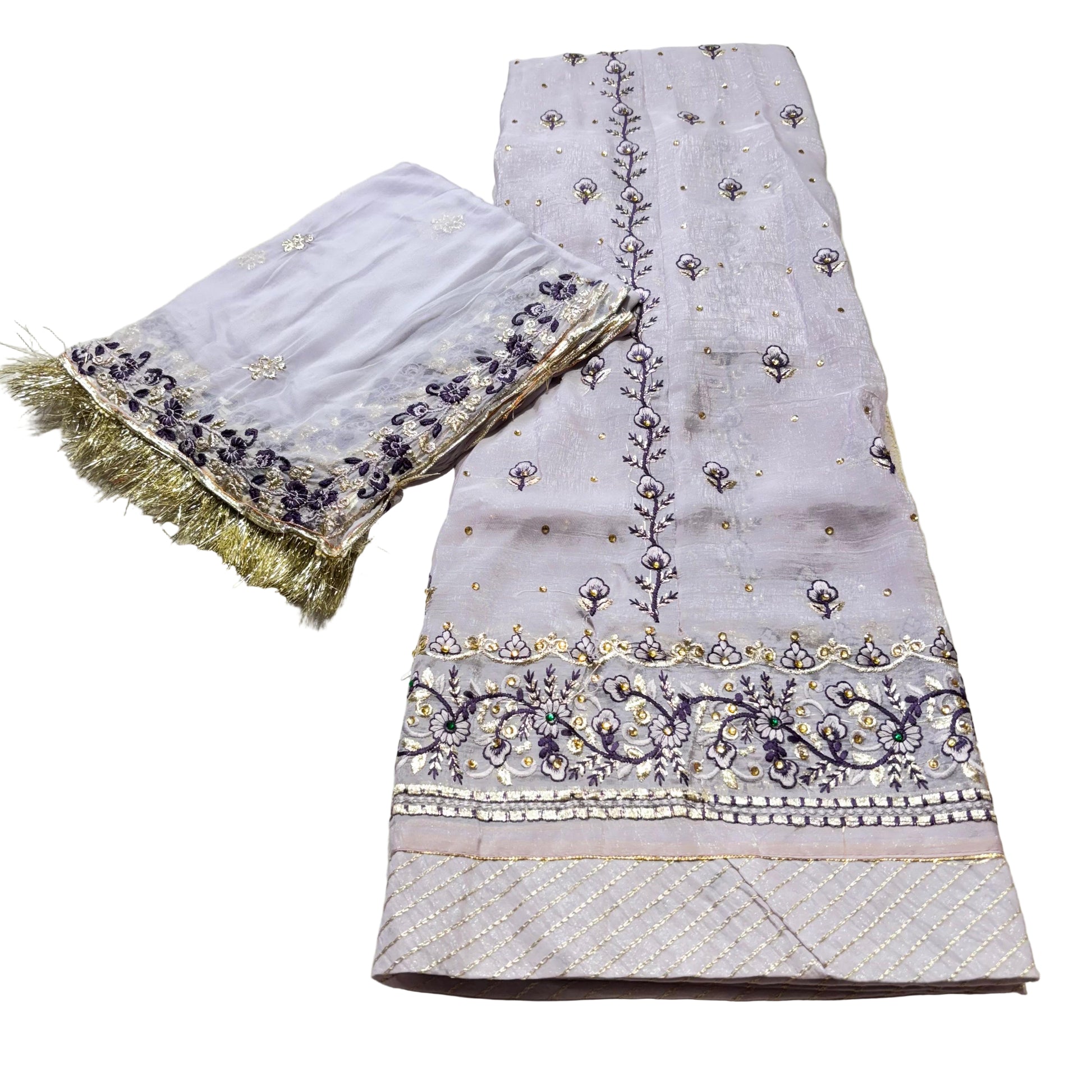 Embroidered fabric with gold and purple details on a light background