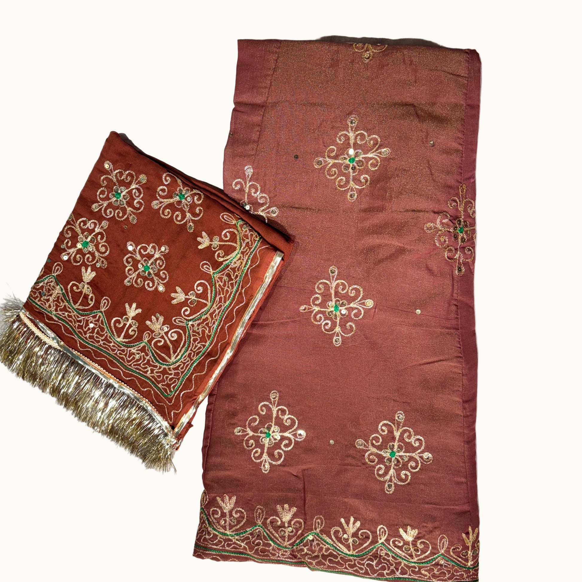 Brown fabric with intricate gold and green embroidery on a light gray background