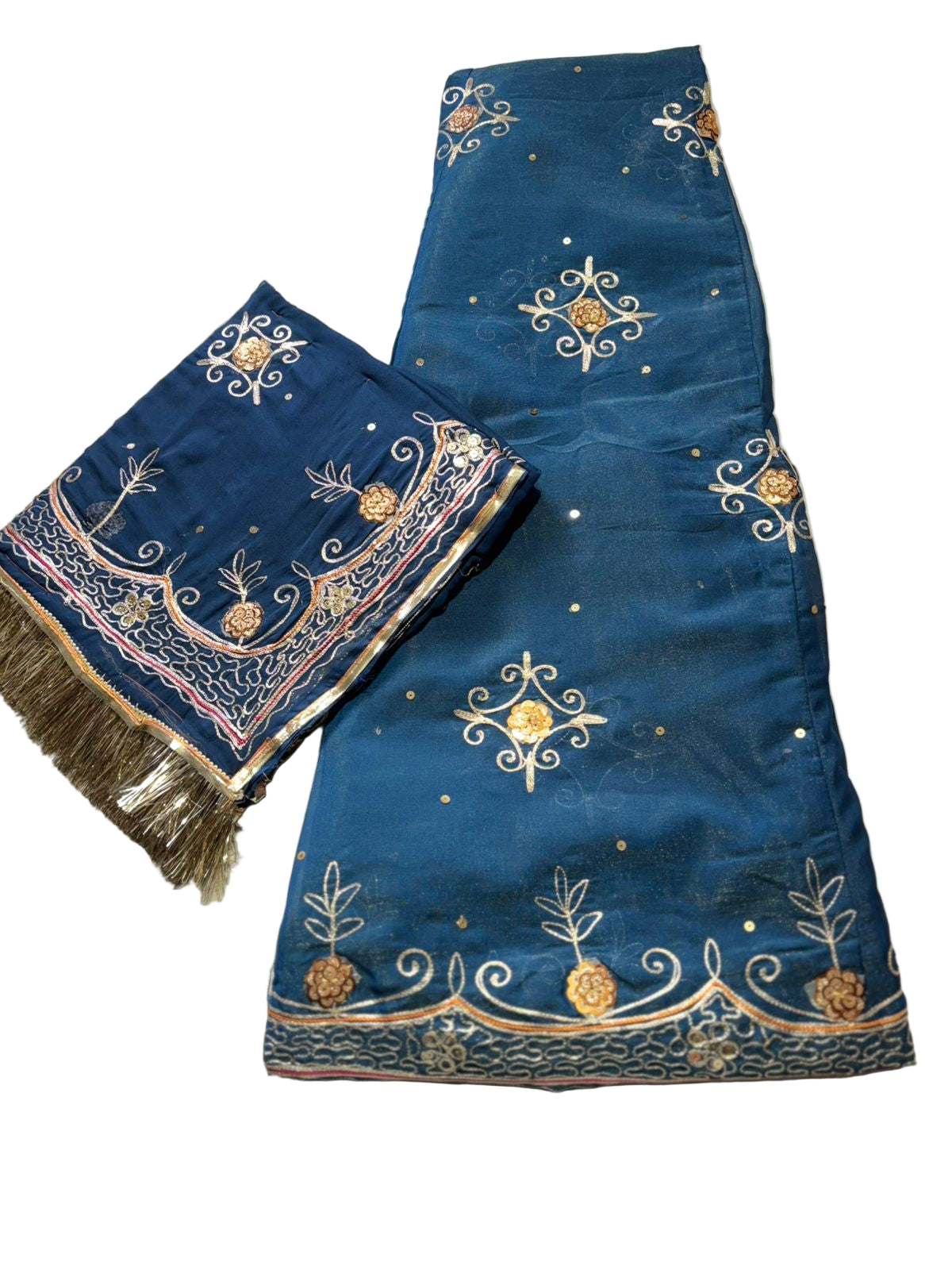 Blue embroidered fabric with intricate patterns on a beige surface