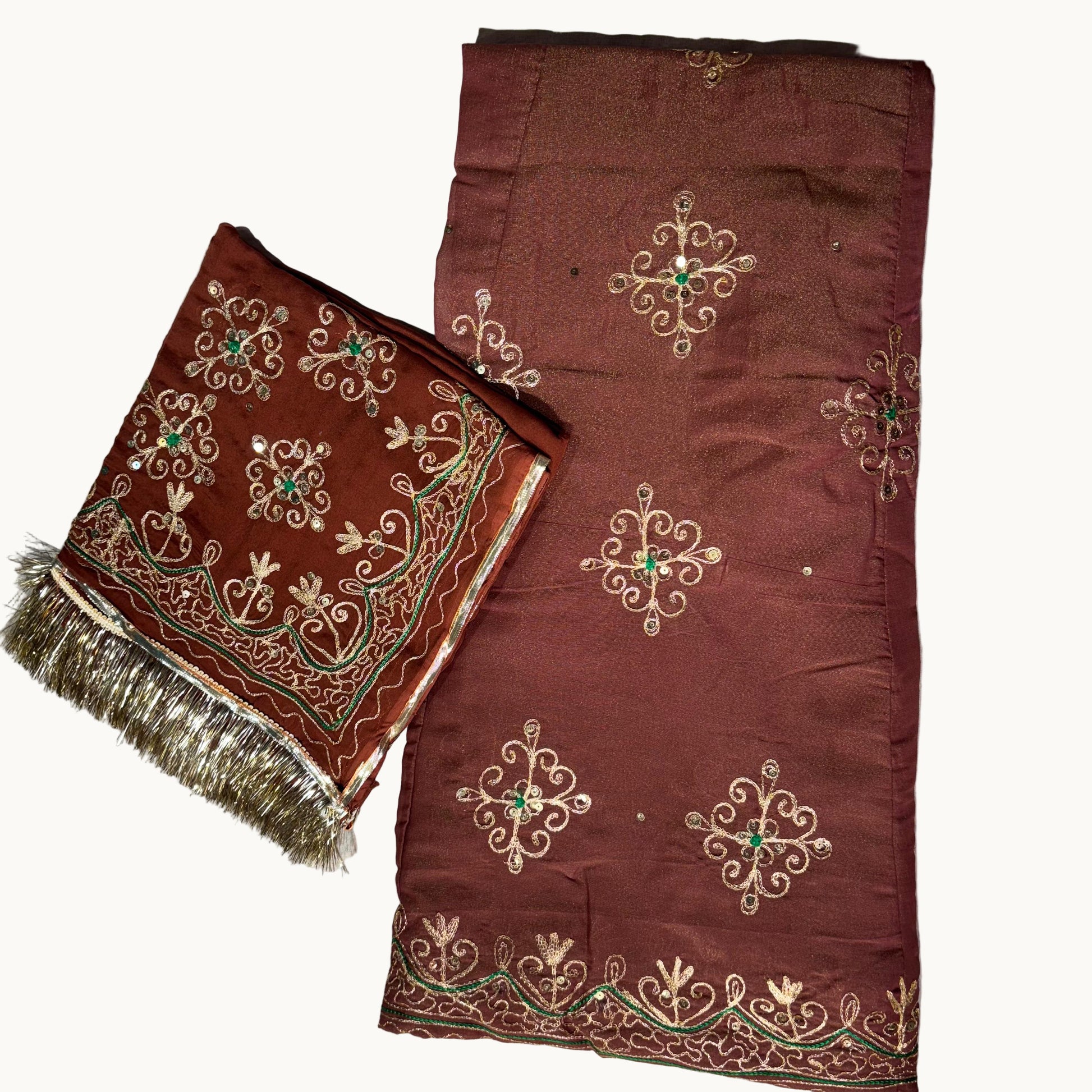Brown fabric with intricate gold and green embroidery on a light gray background