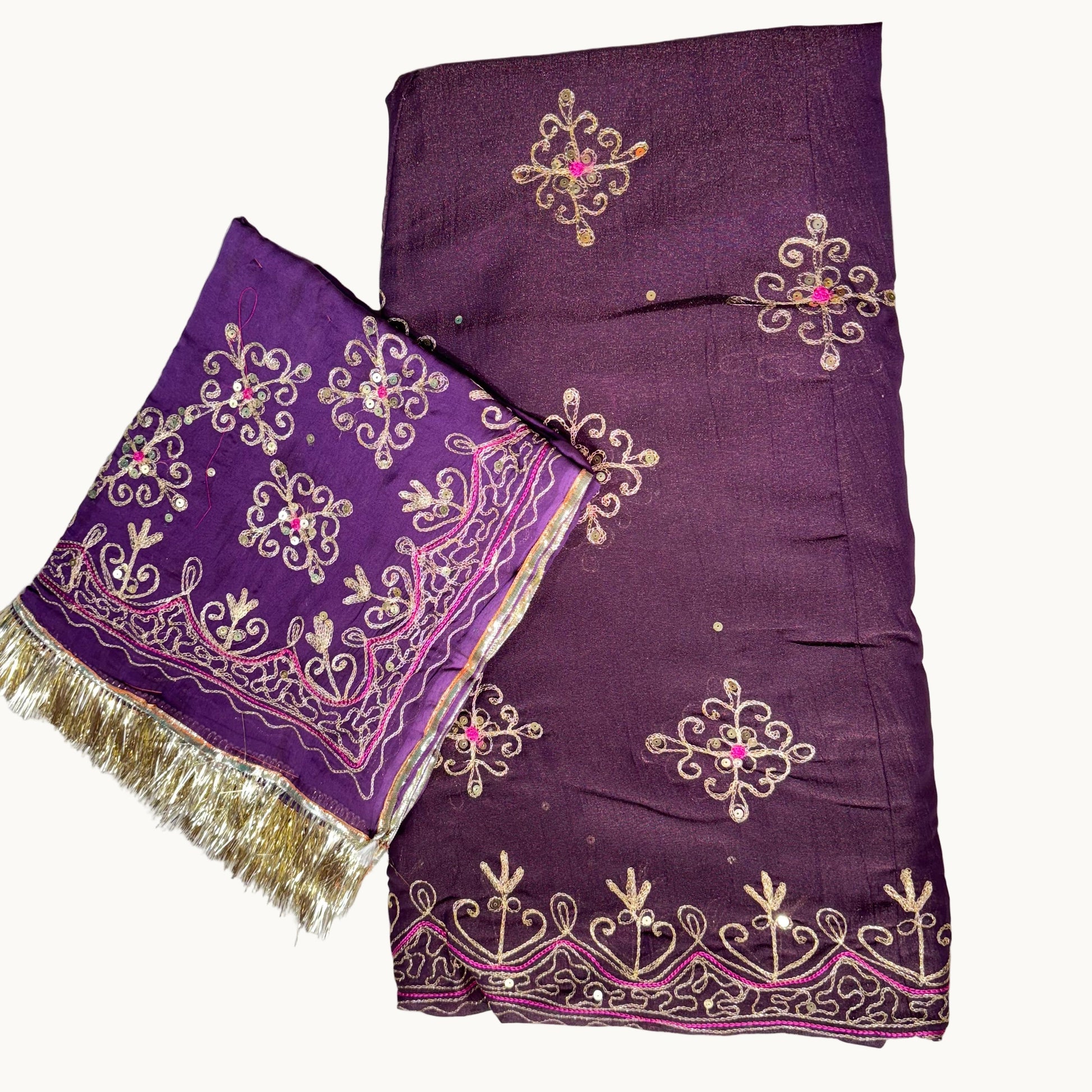 Purple embroidered fabric with gold patterns on a white background
