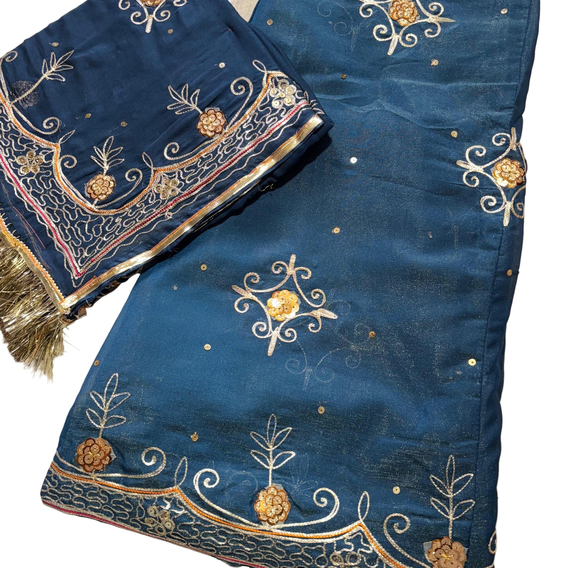 Blue embroidered fabric with gold and white patterns on a beige background
