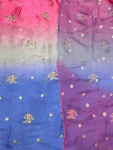 Gradient fabric with pink, blue, and purple colors and floral patterns.