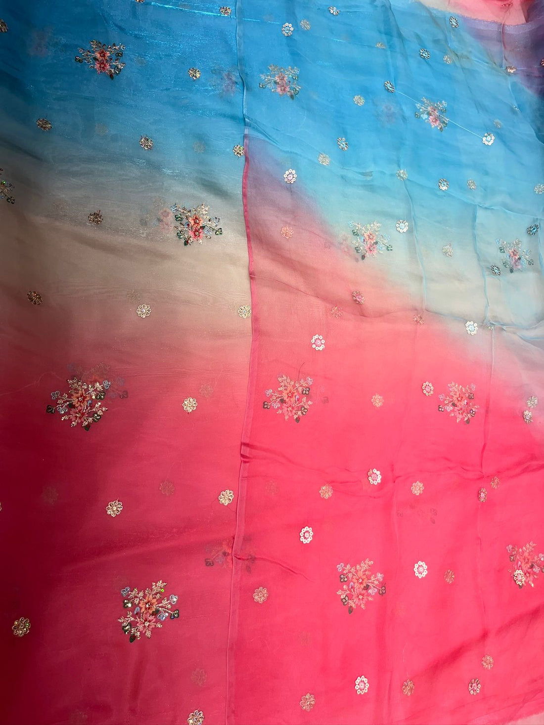 Gradient fabric with pink, blue, and purple colors and floral patterns.