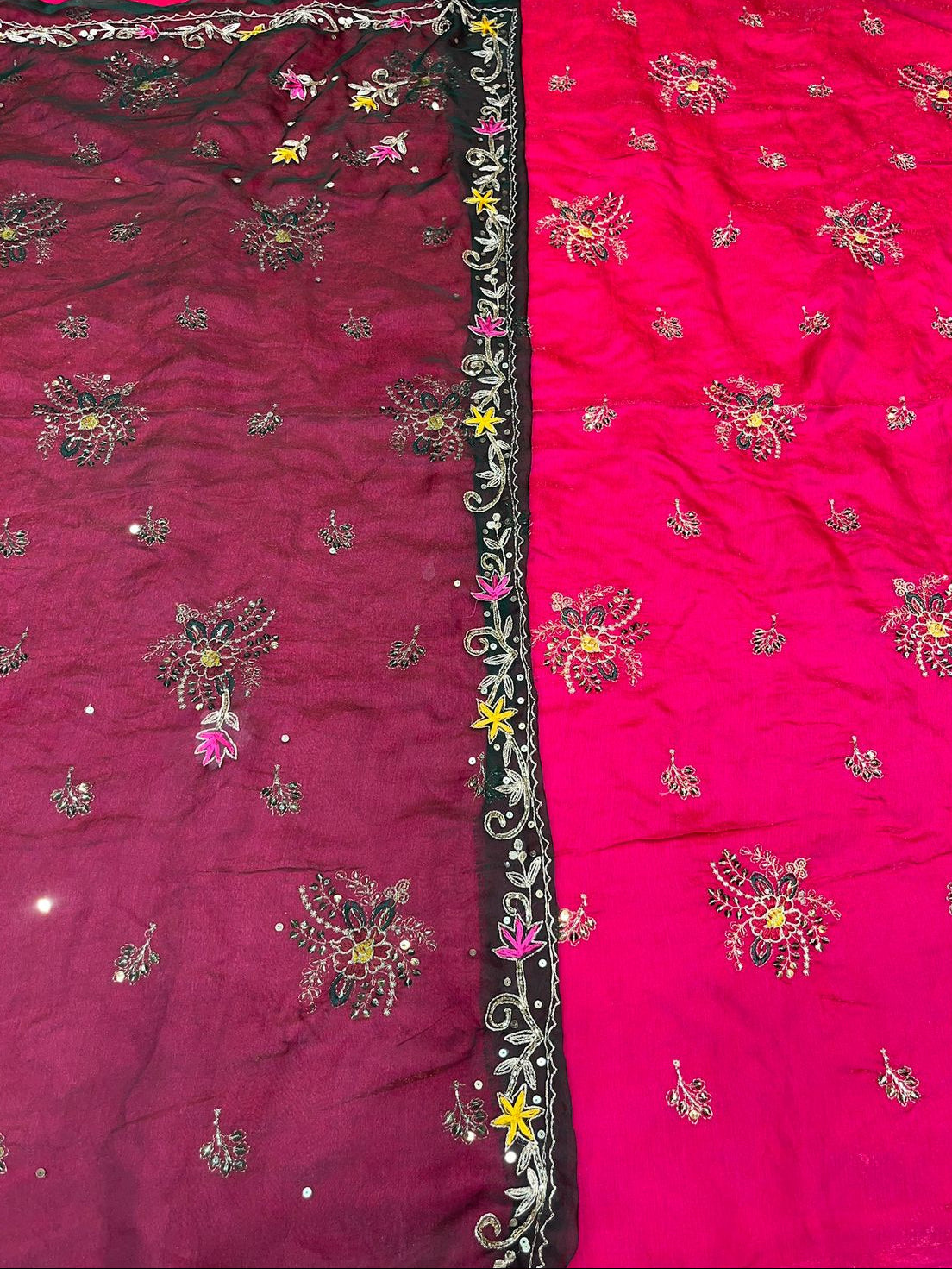 Two pieces of fabric with intricate embroidery, one in dark red and the other in pink, on a white background.