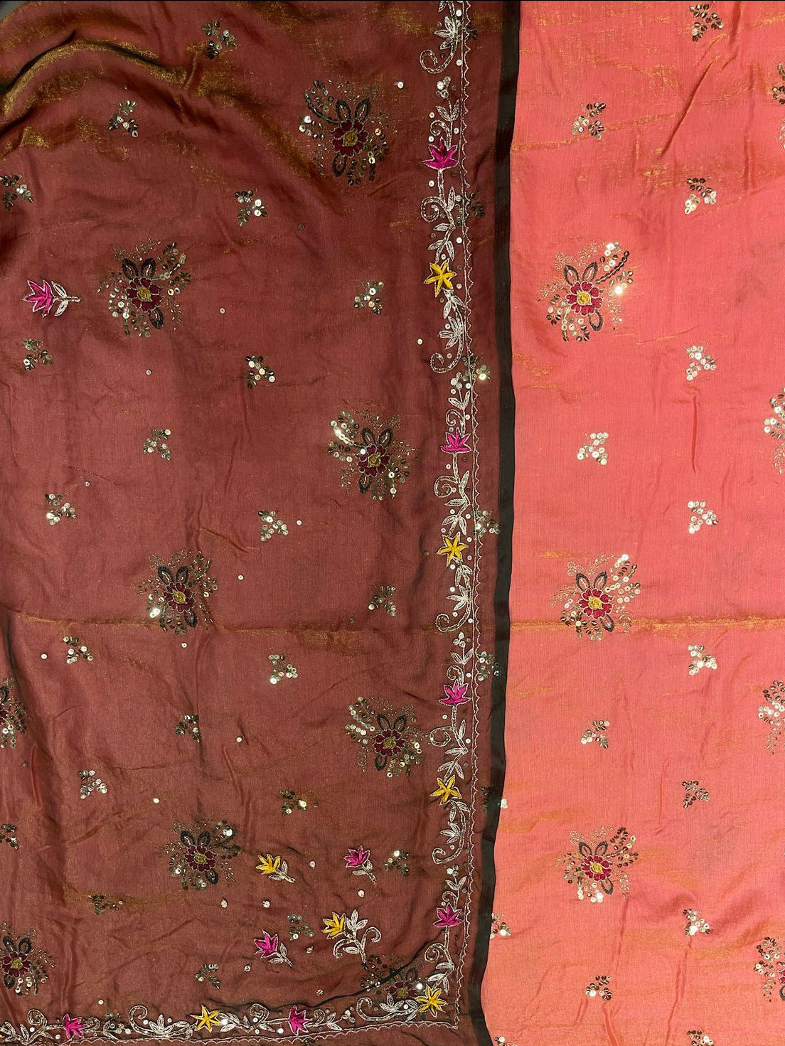 Two pieces of fabric with floral embroidery, one pink and one brown.