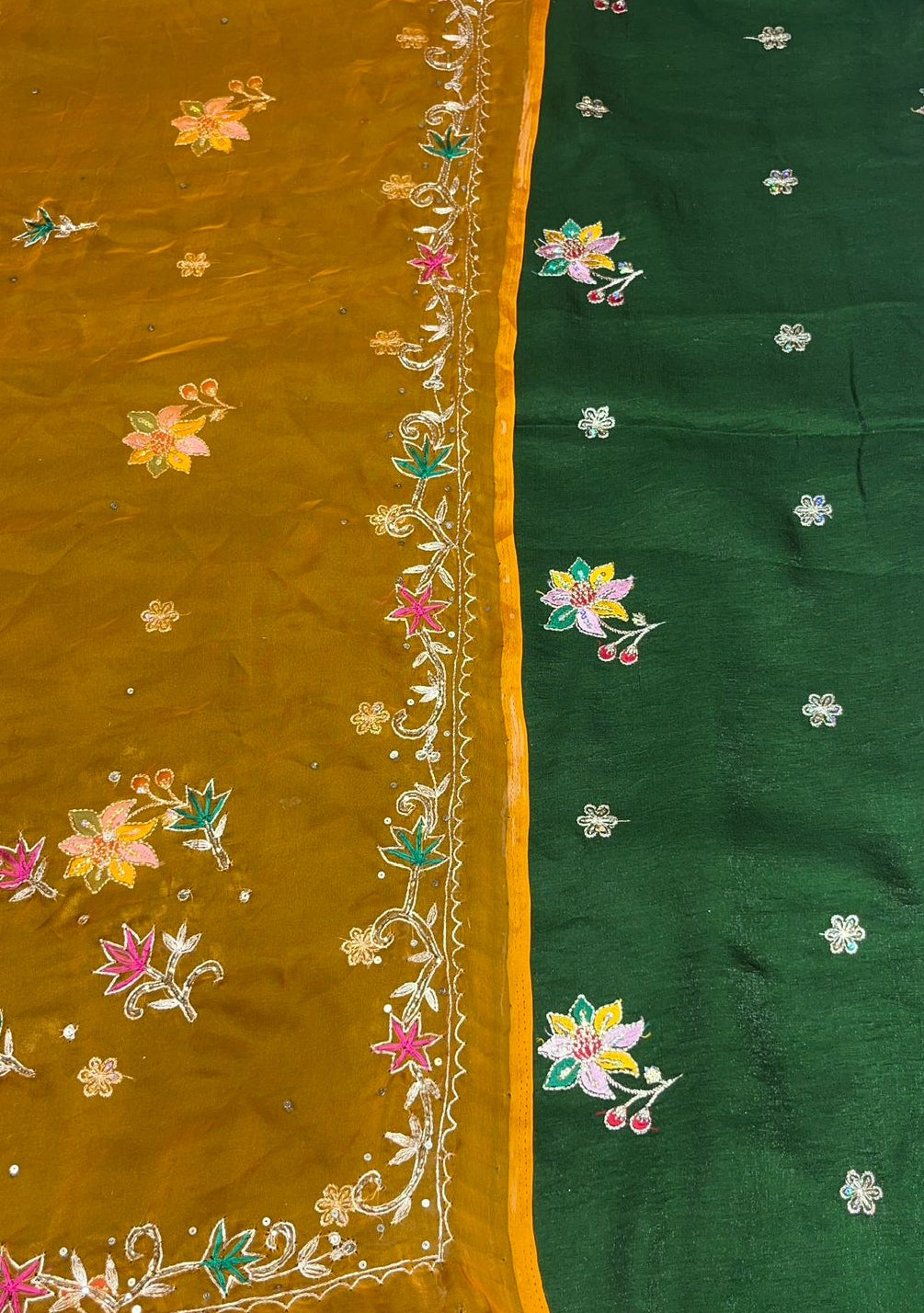 Two sections of fabric with floral embroidery, one in mustard yellow and the other in green.