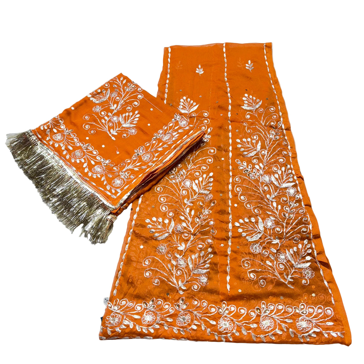Orange fabric with white floral patterns on a light gray background