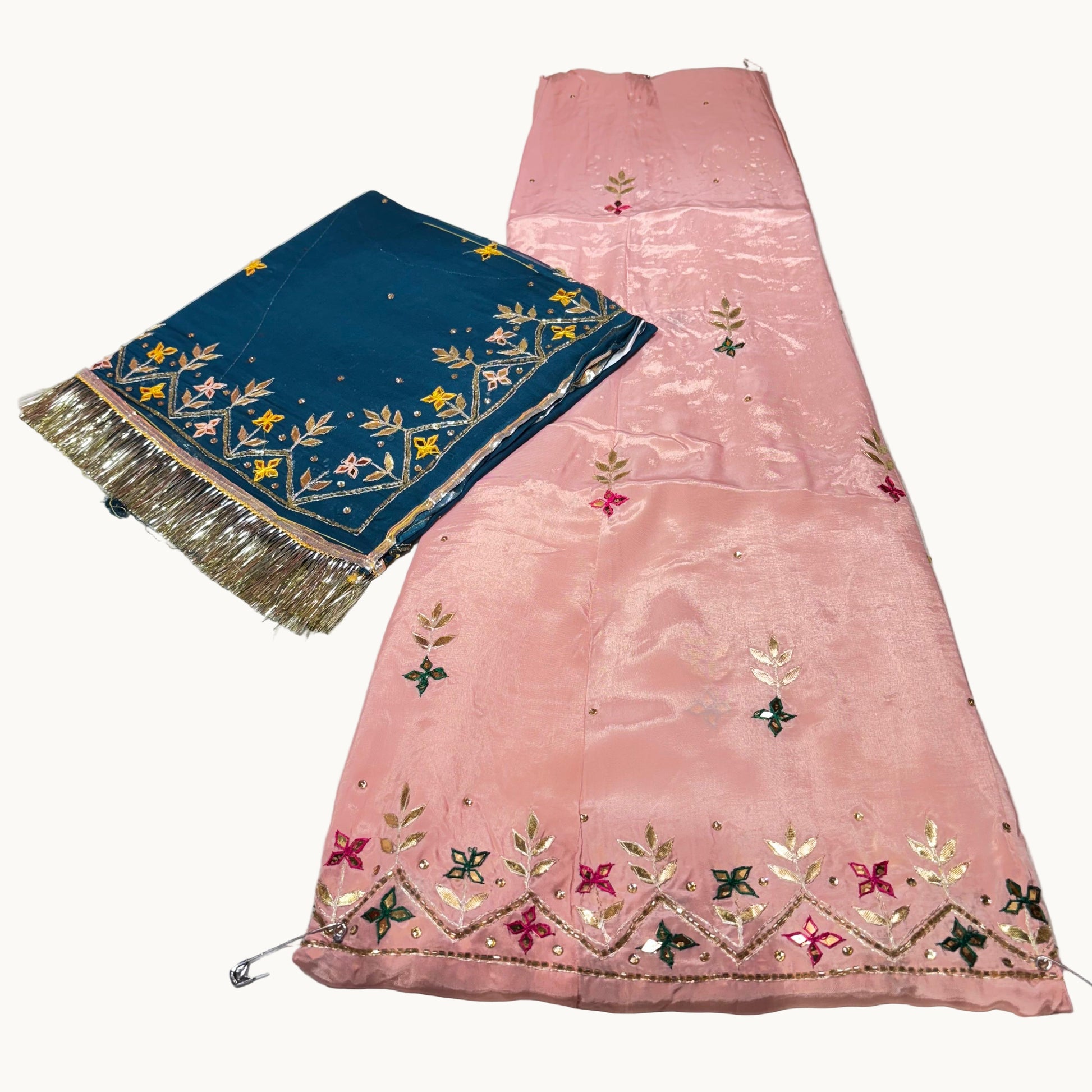 Pink embroidered fabric with a blue border on a white background