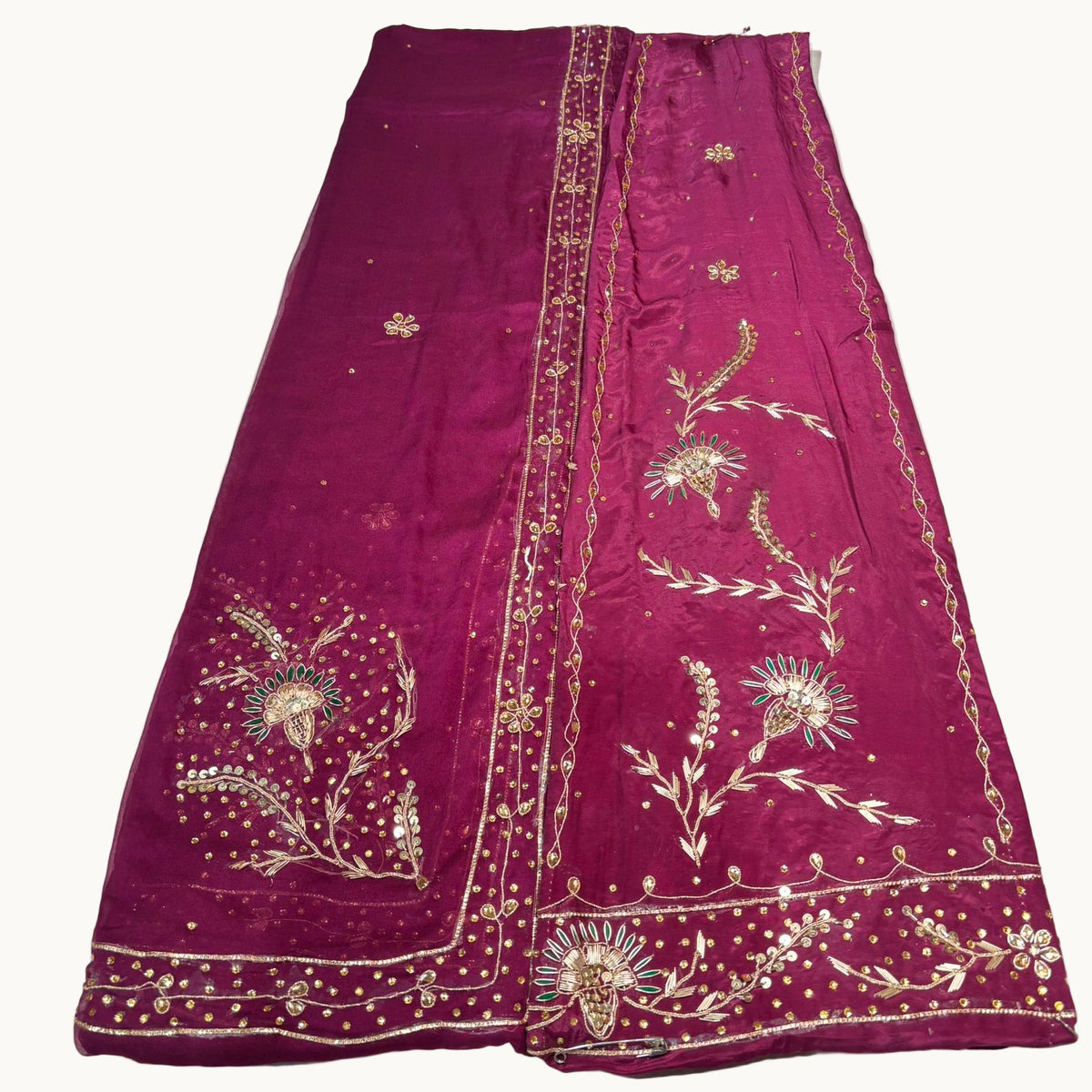 Purple embroidered fabric on a white surface