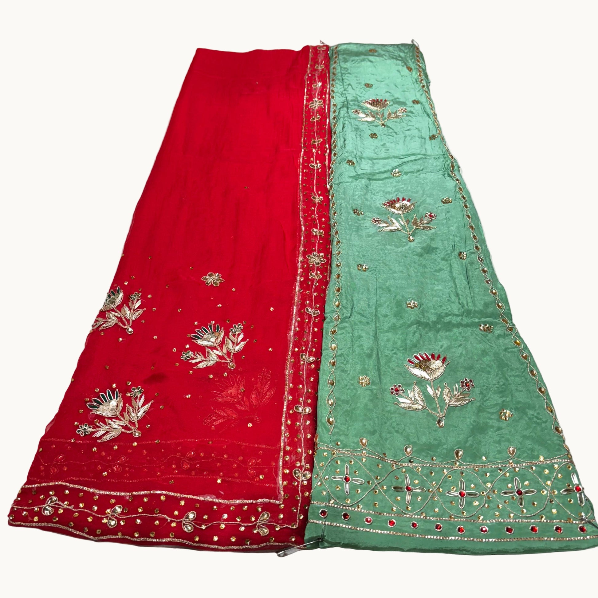 Red and green embroidered fabric on a white background