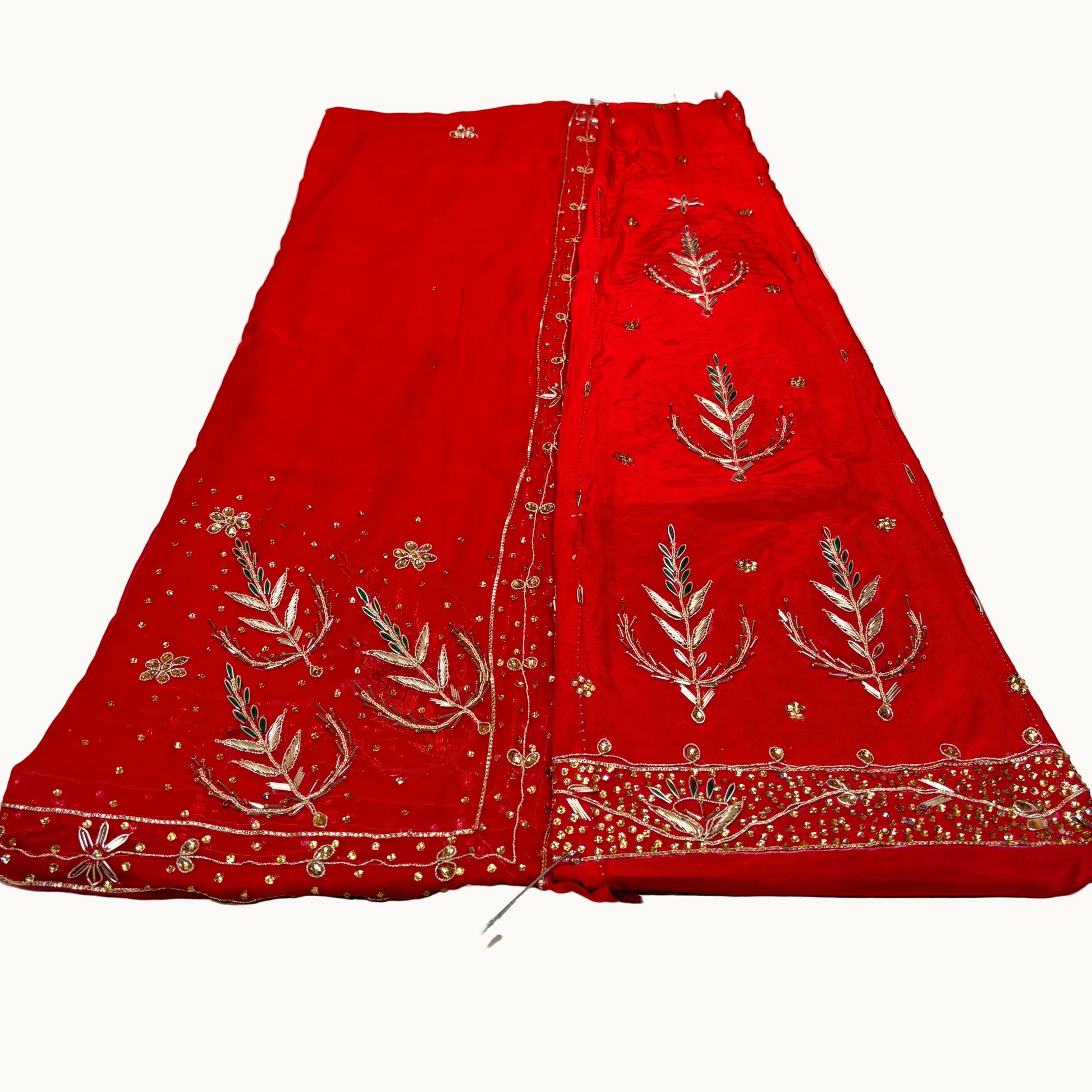 Red embroidered fabric on a white background
