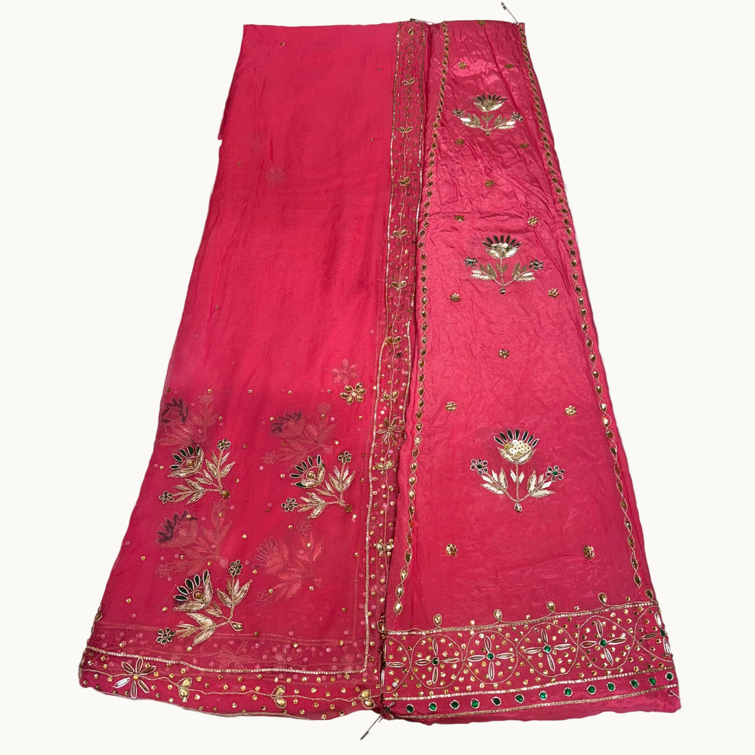 Red embroidered fabric on a light gray background