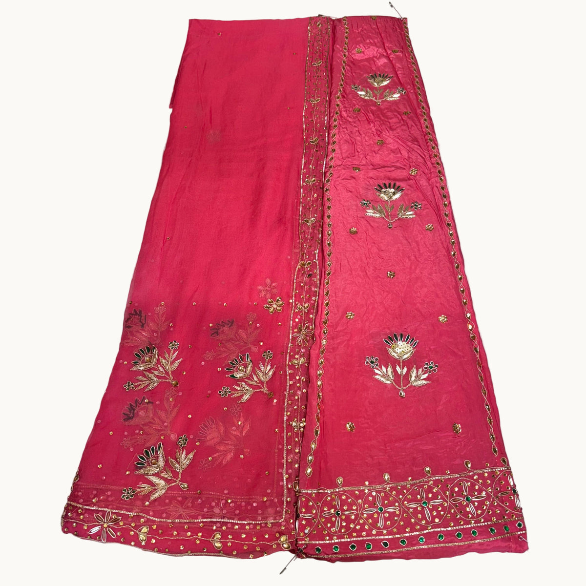 Red embroidered fabric on a light gray background