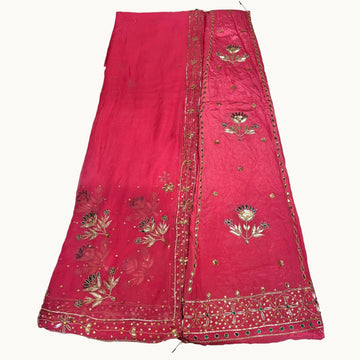 Red embroidered fabric on a light gray background