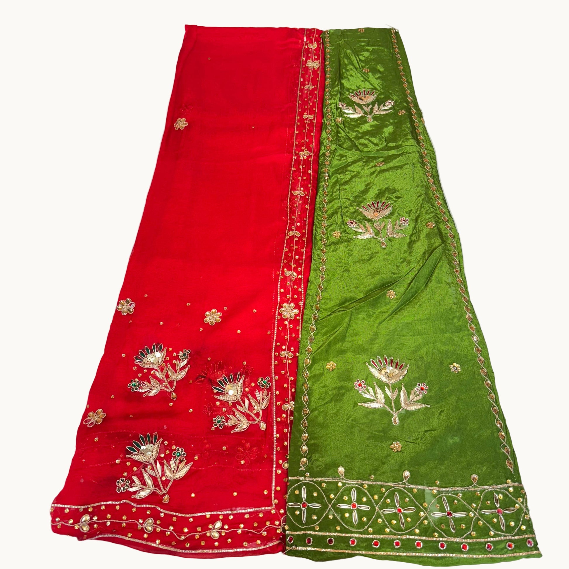 Red and green sarees with floral embroidery on a white background