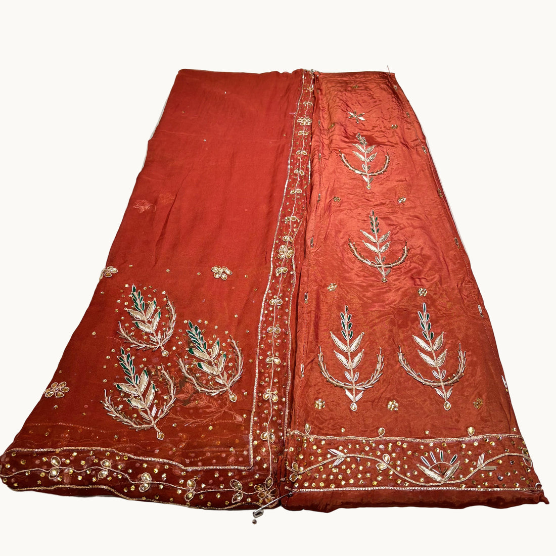 Red embroidered fabric on a white surface