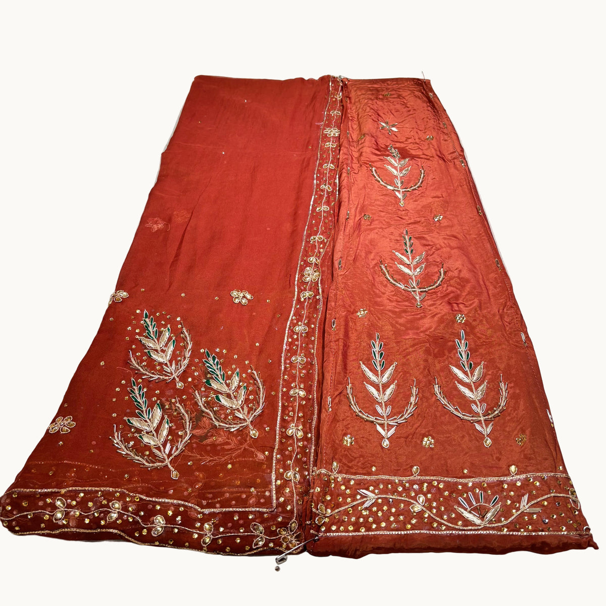 Red embroidered fabric on a white surface