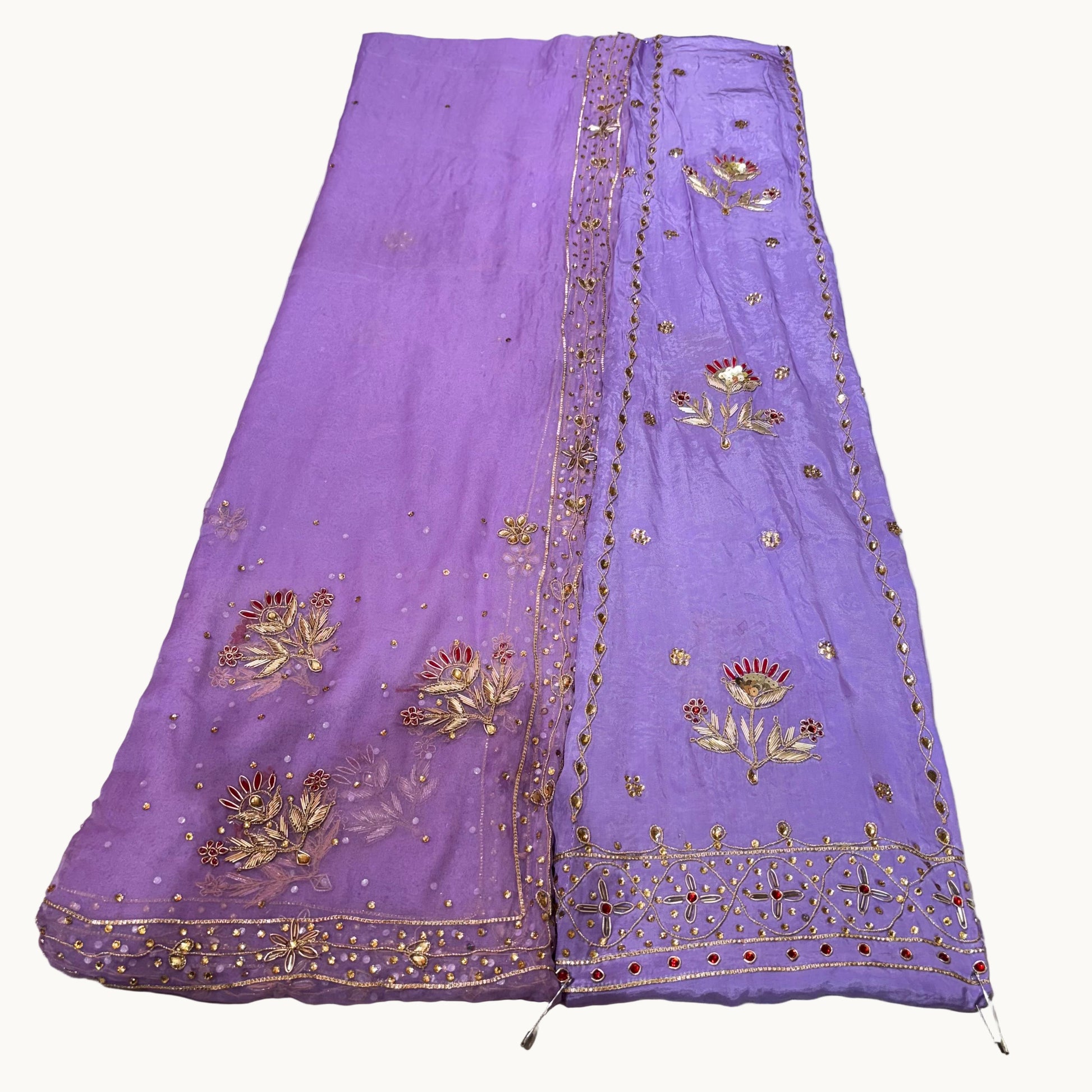 Purple embroidered fabric on a light gray background