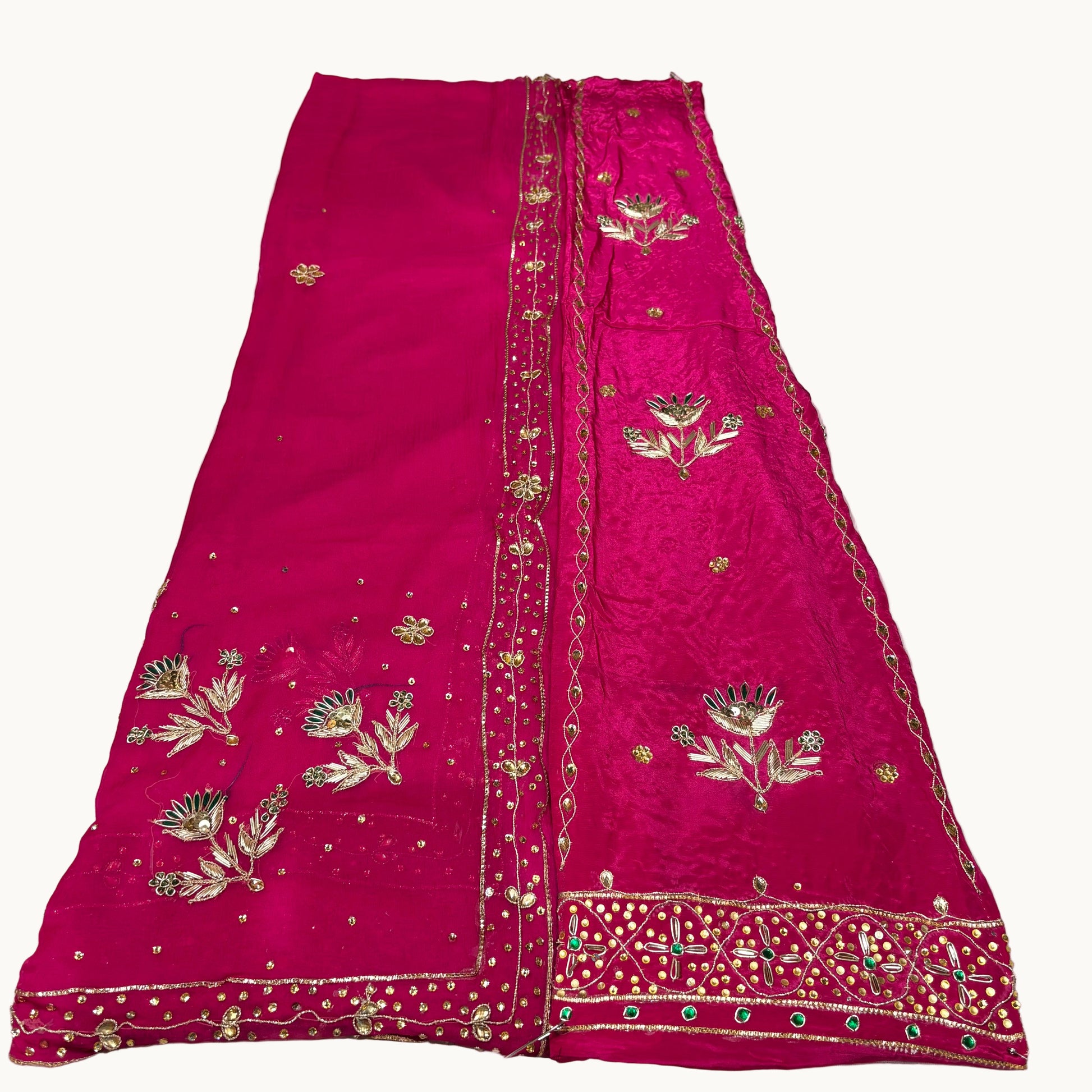 Pink embroidered fabric on a white background