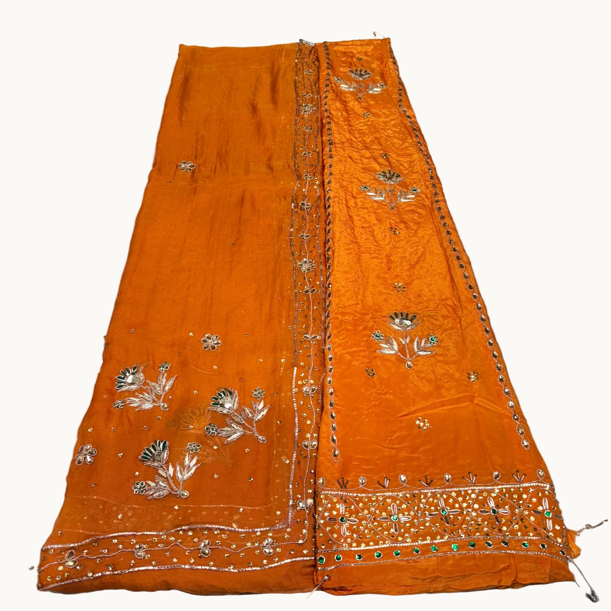 Orange embroidered fabric on a white background