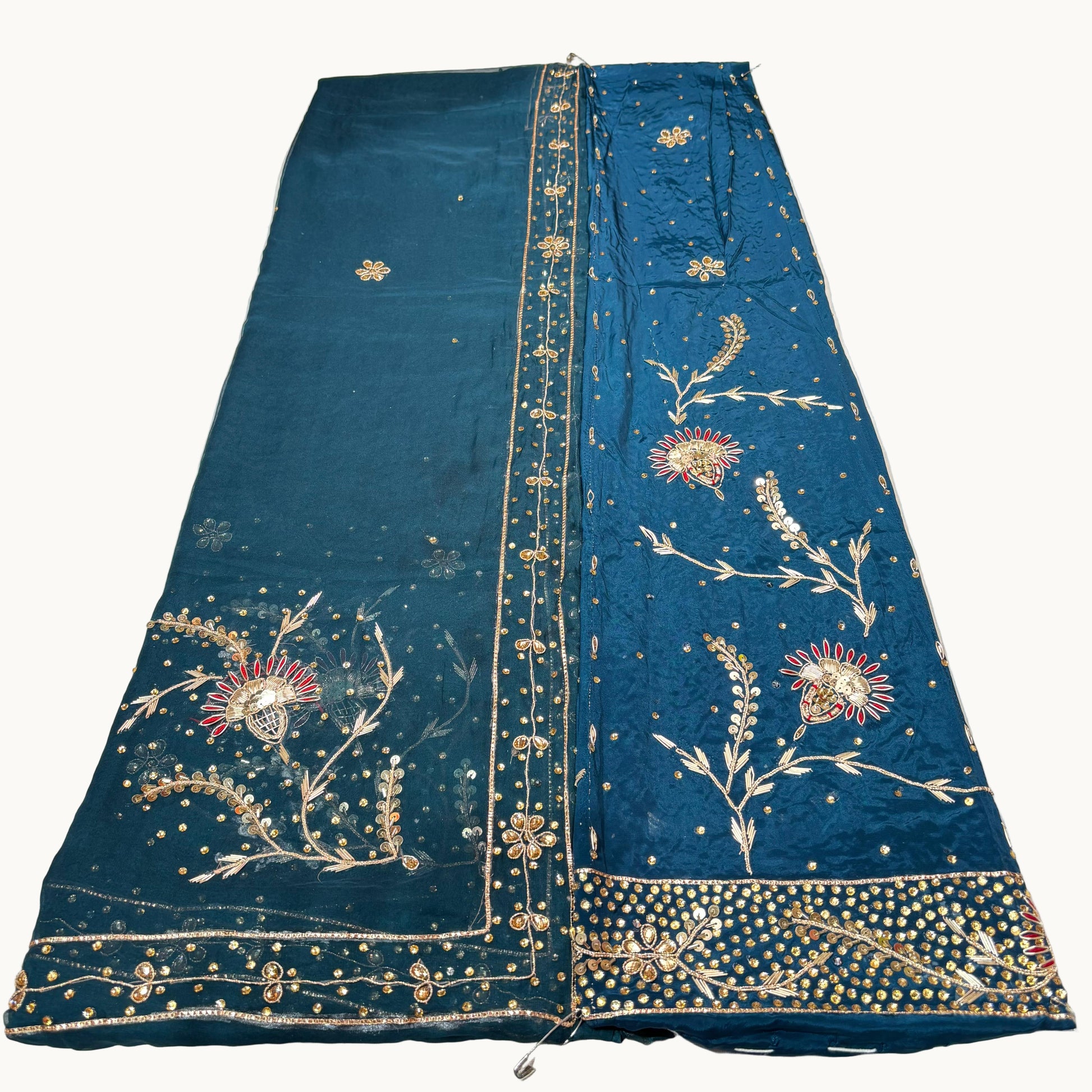Blue embroidered fabric on a white surface