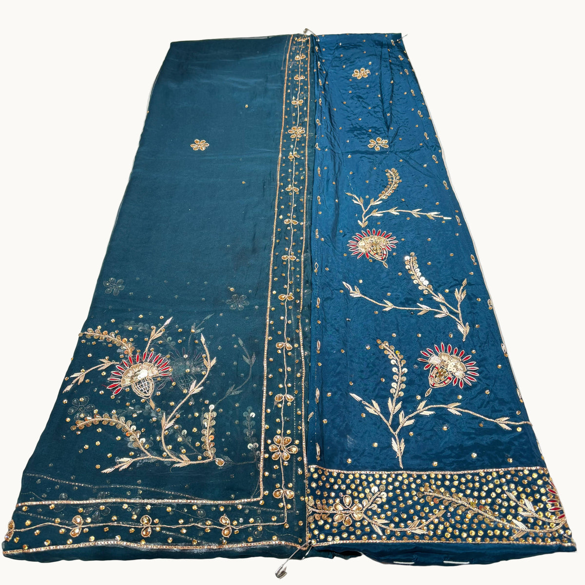 Blue embroidered fabric on a white surface