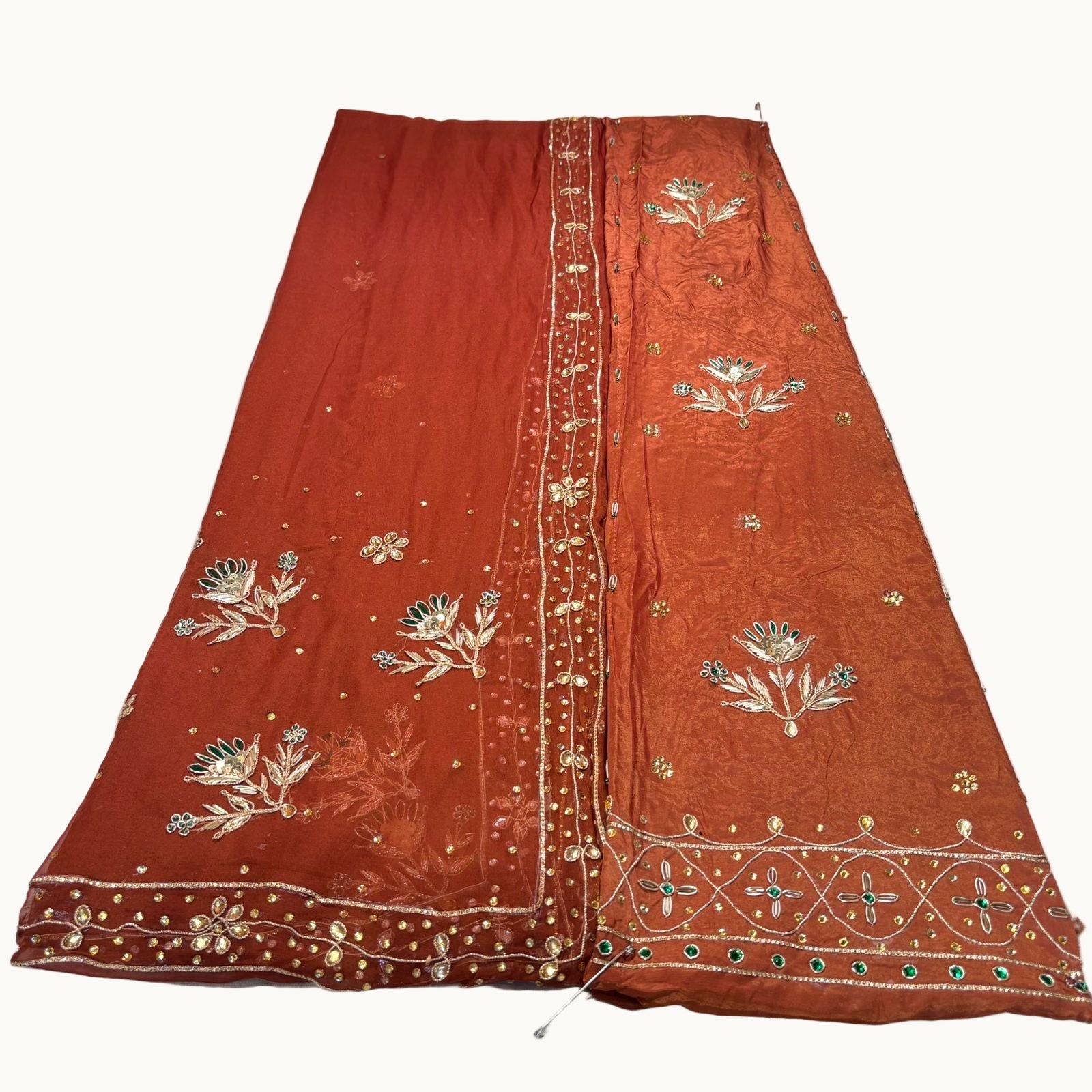 Brown embroidered fabric on a white background