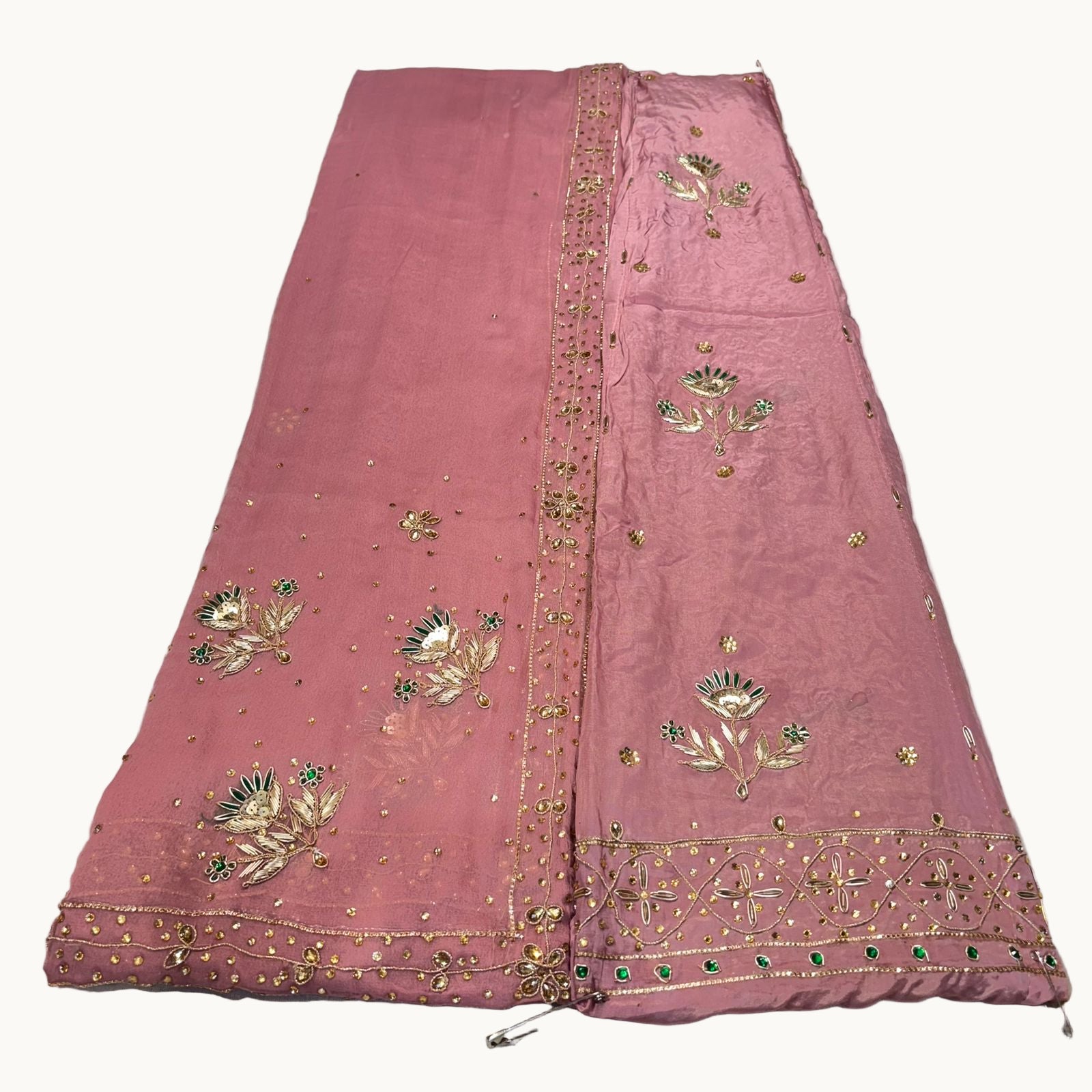 Pink embroidered fabric on a white background
