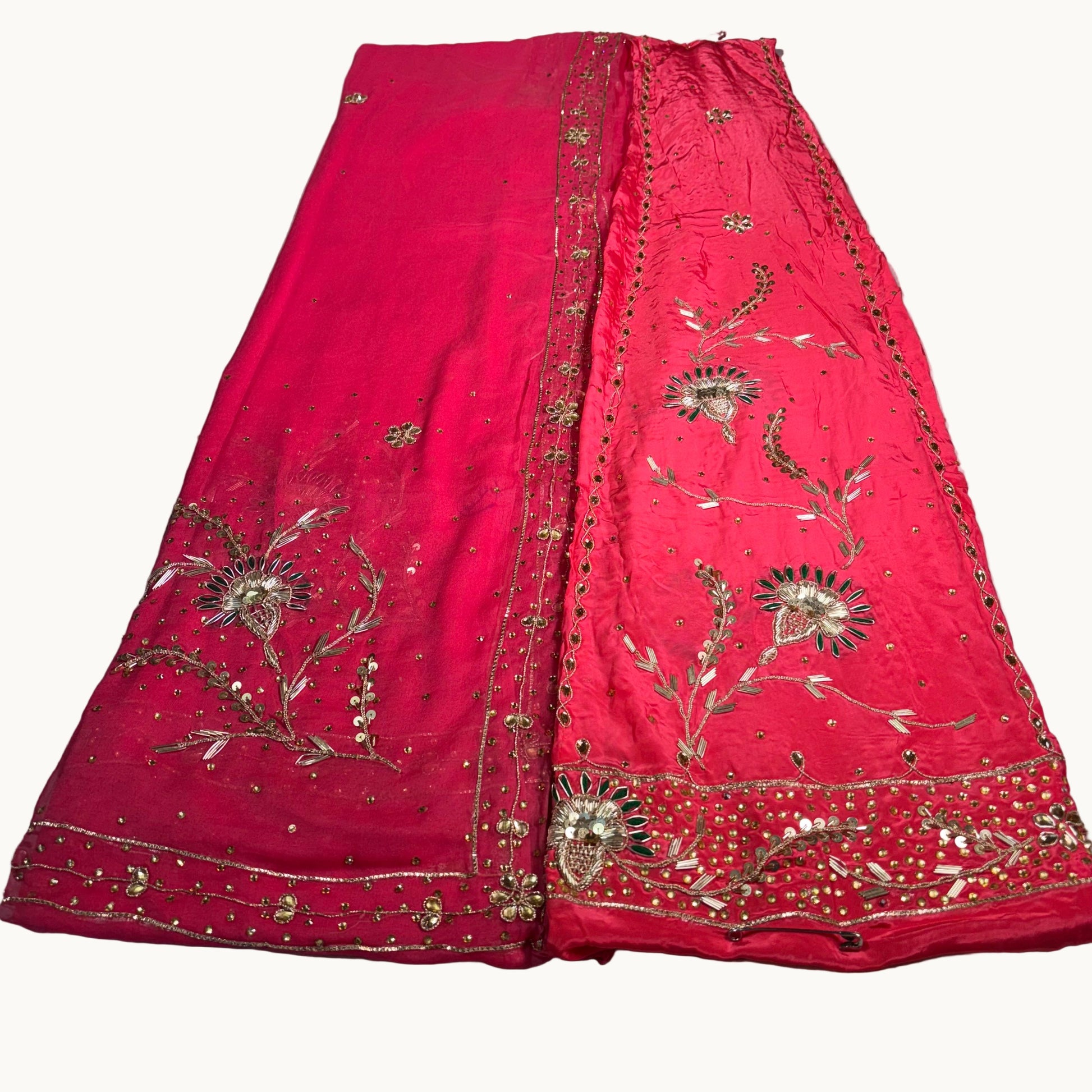 Red embroidered fabric on a light gray surface