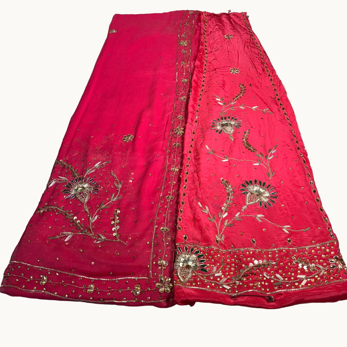 Red embroidered fabric on a light gray surface