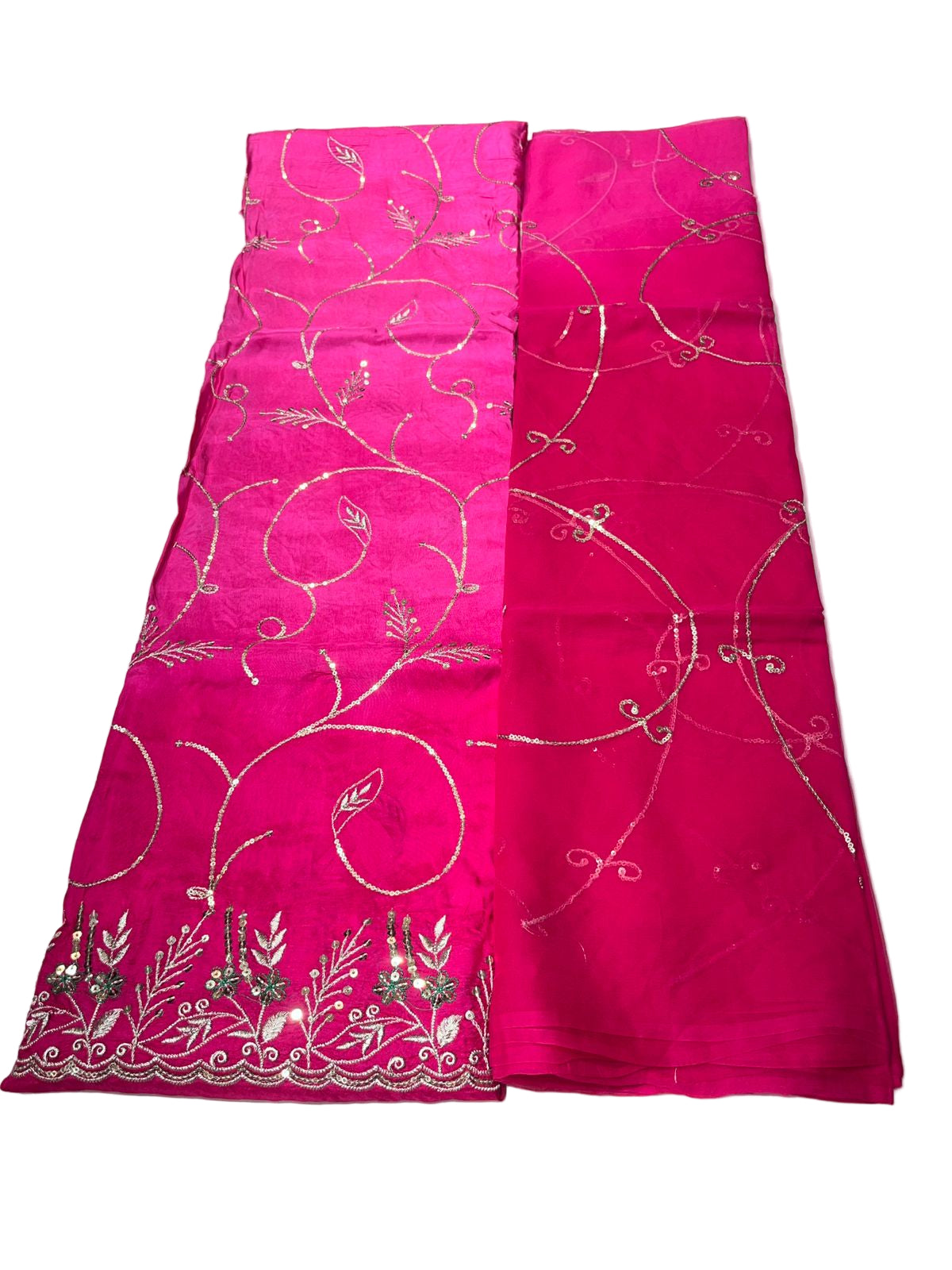 Pink fabric with white floral patterns on a light gray surface