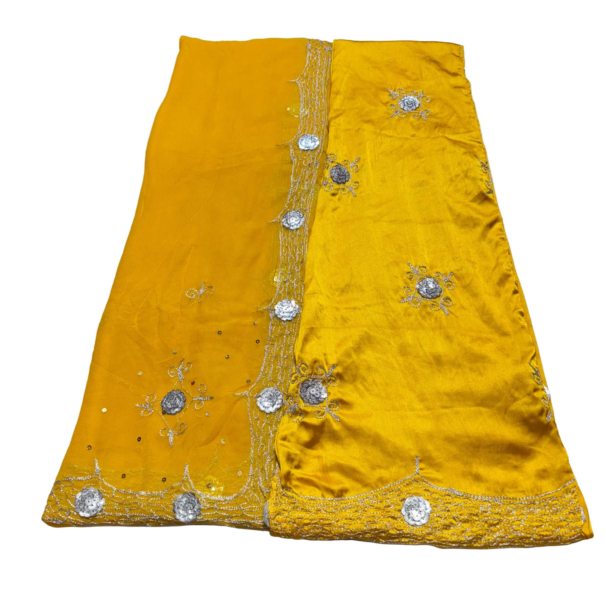 Yellow fabric with silver embroidery on a gray surface