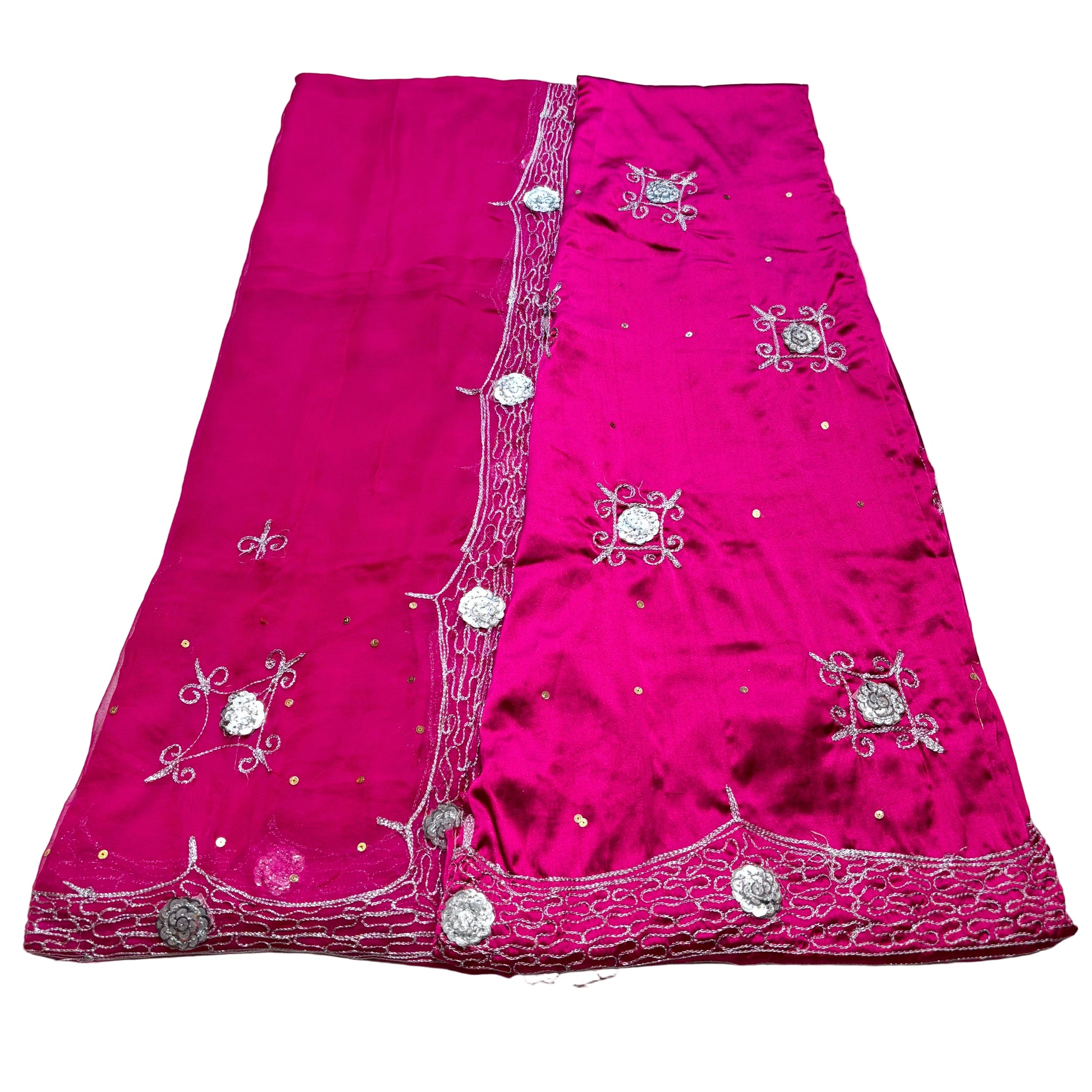 Pink fabric with silver embroidery on a light gray background