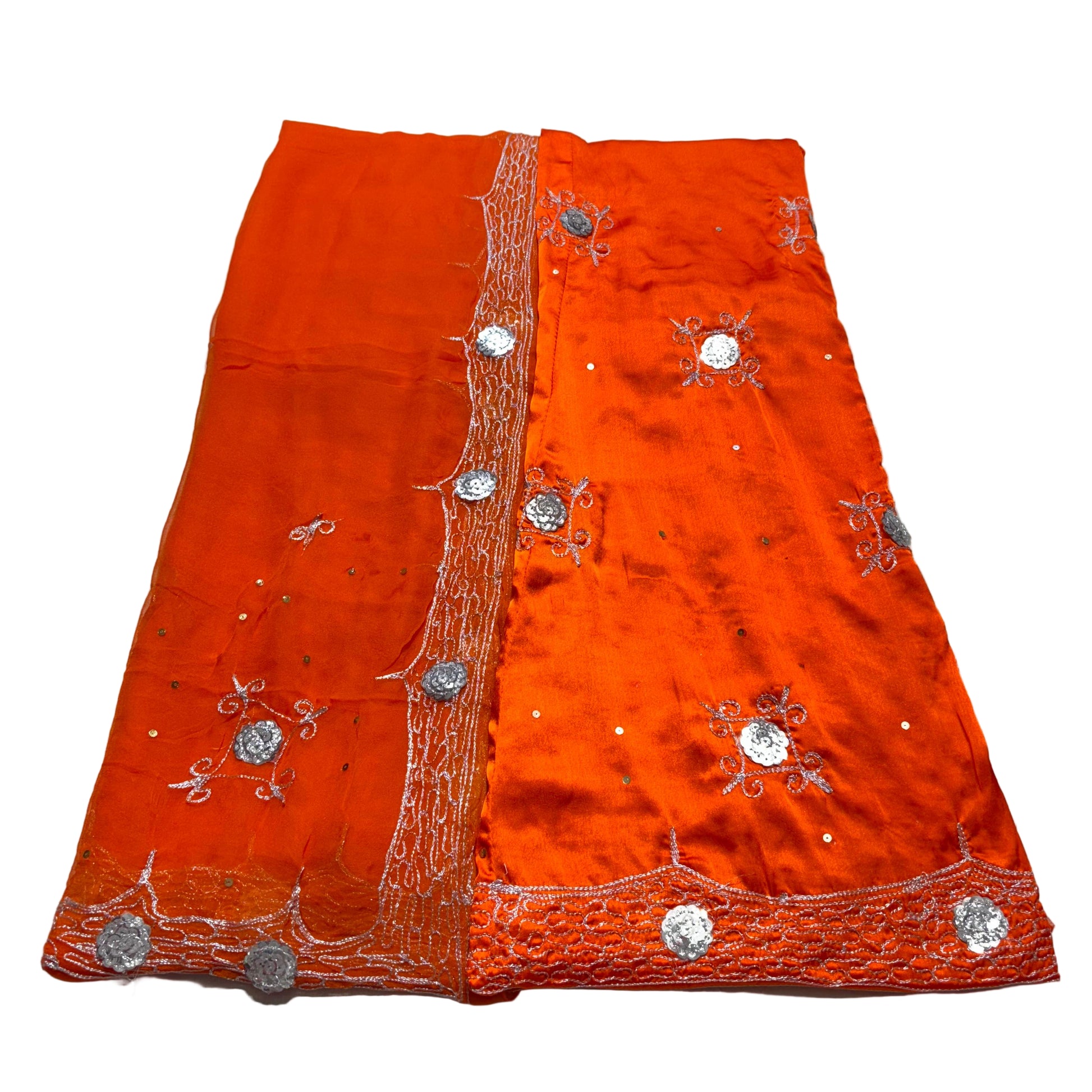 Orange fabric with silver embroidery on a light gray background