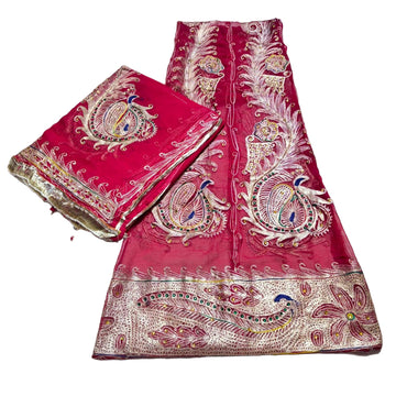 Pink fabric with intricate gold and white embroidery on a white background
