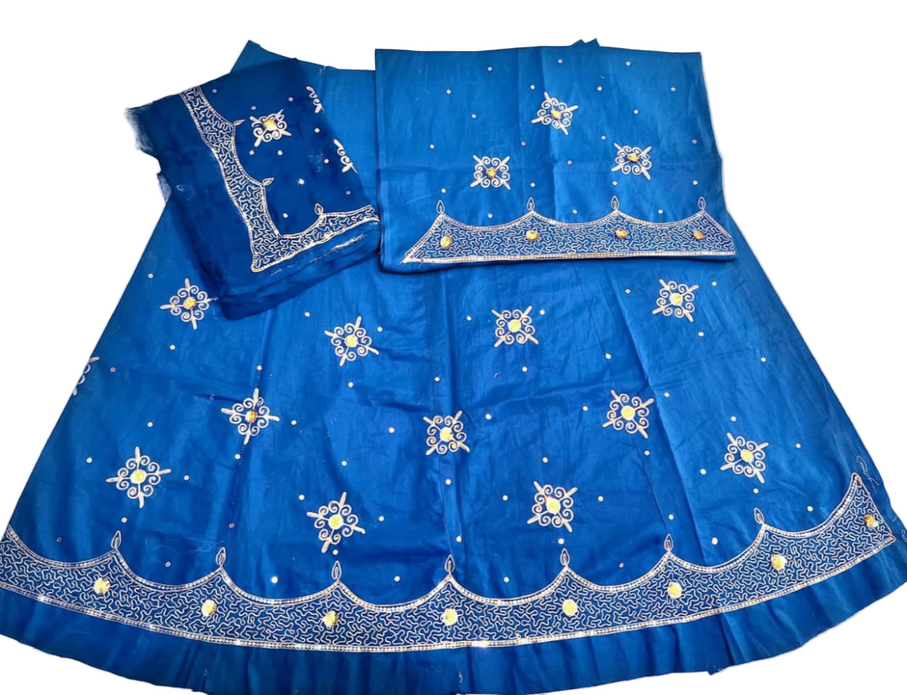 Blue embroidered traditional outfit on a light background
