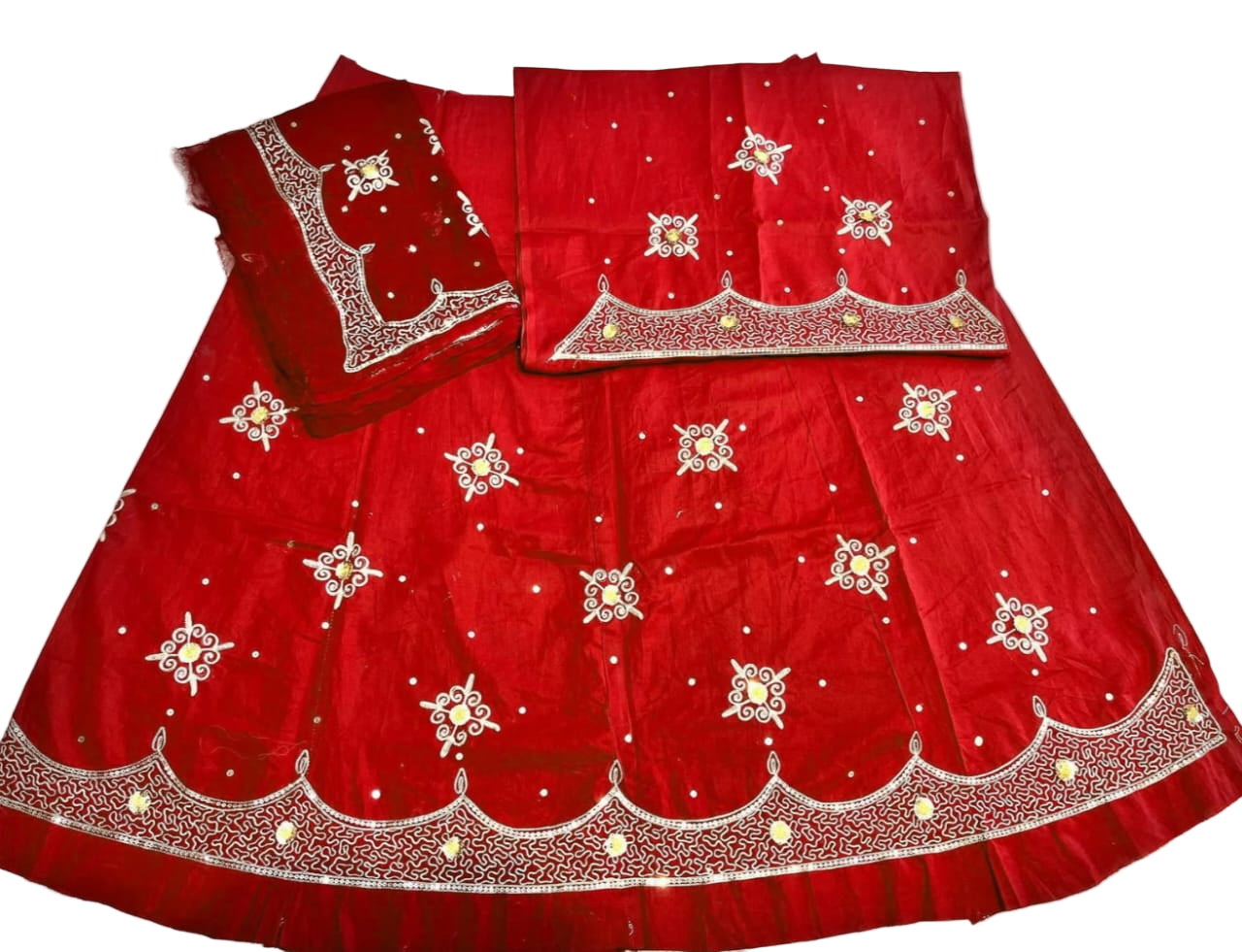 Red embroidered traditional outfit on a white background