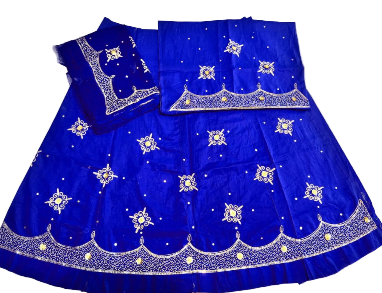 Blue embroidered traditional outfit on a white background
