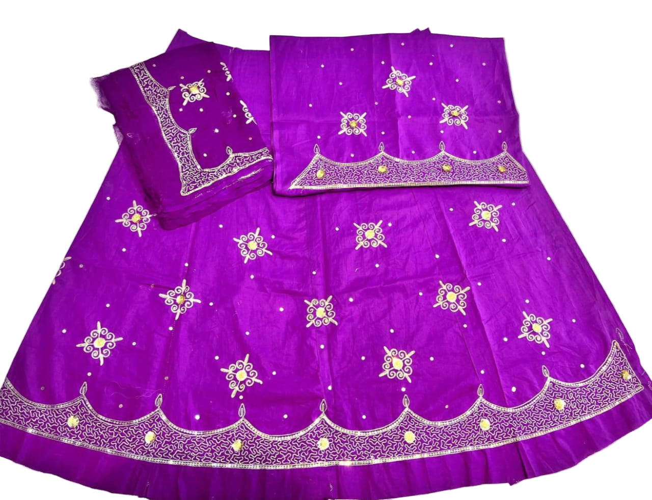 Purple traditional outfit with white embroidery on a light background