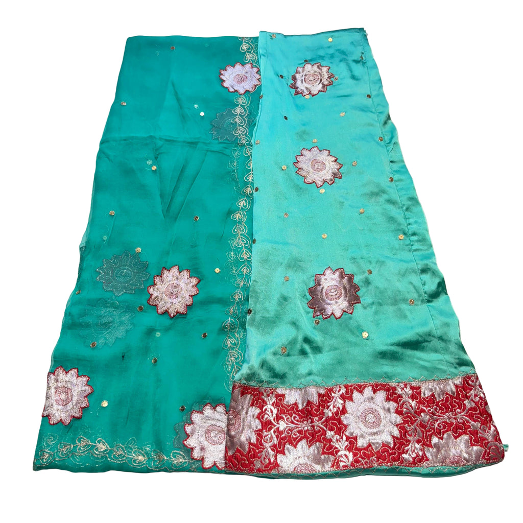 Turquoise fabric with floral embroidery on a light gray background
