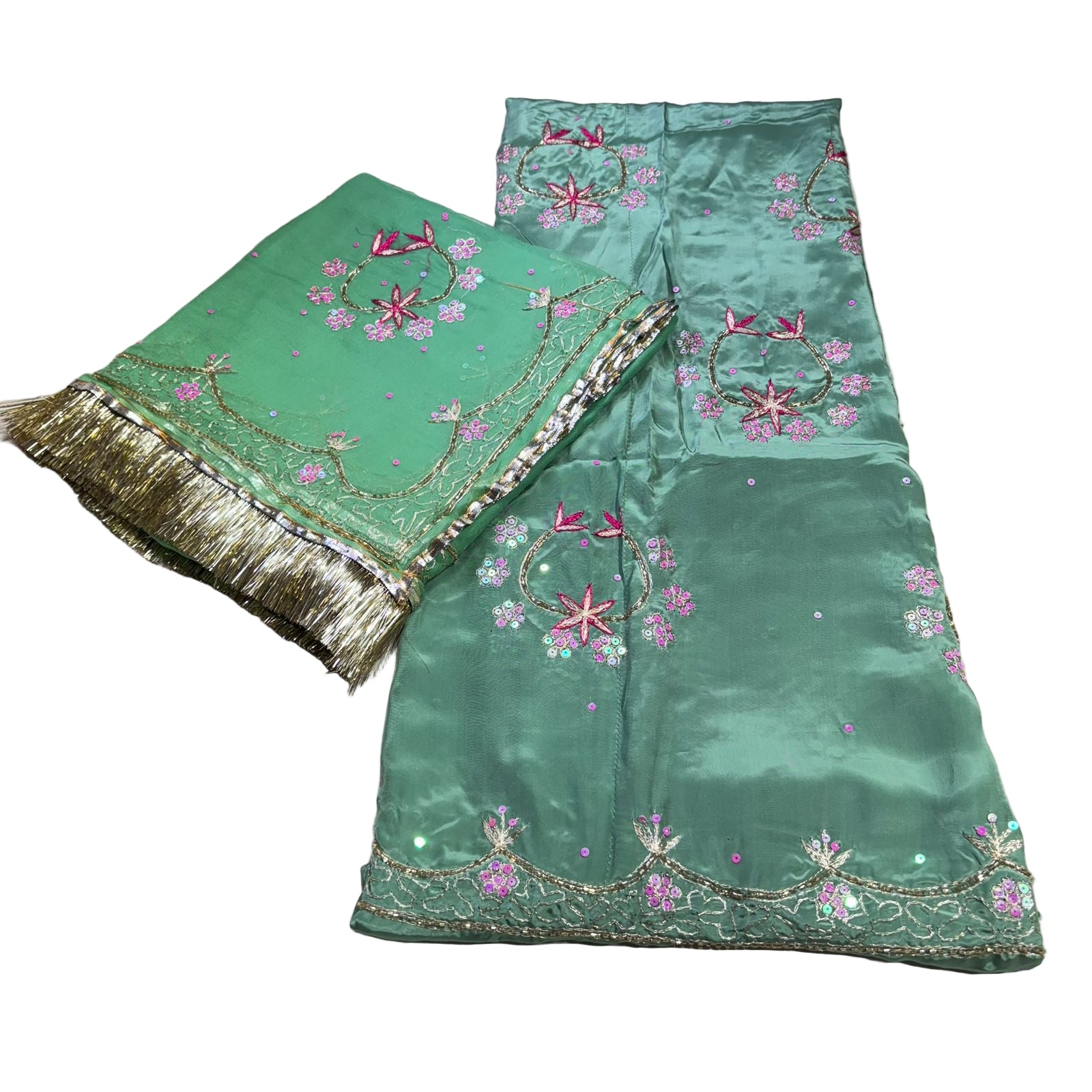 Green fabric with floral embroidery and gold trim on a light background