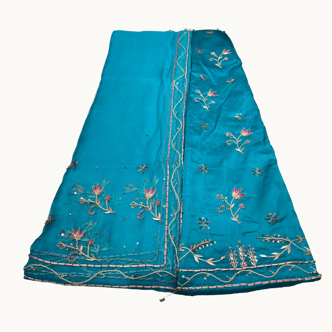 Blue embroidered fabric on a white surface